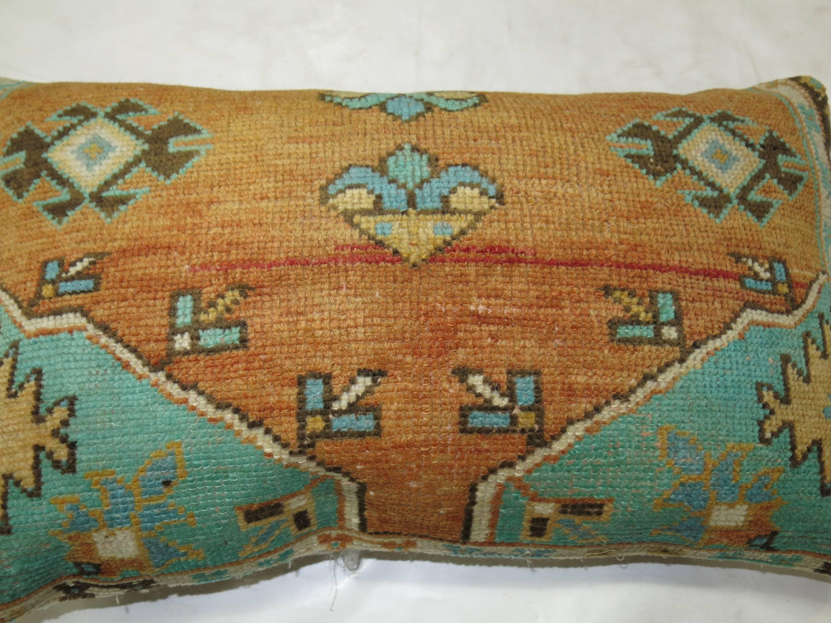 A large Turkish pillow in green and orange.