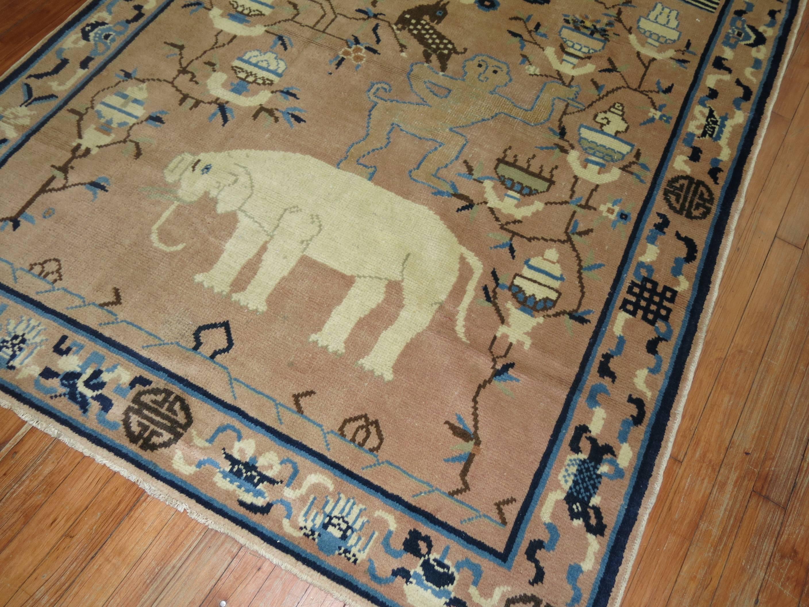 A rather unusual pictorial Tibetan rug with what looks to be a human figure sporting a tail and standing on an elephant surrounded by different animals and elements.

4'10'' x 6'9''