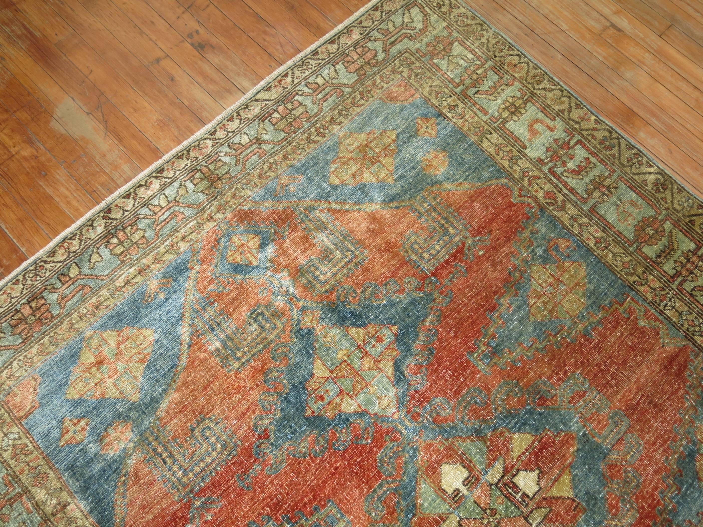 Squarish size one of a kind antique Persian Malayer rug in orangey red tones and soft blue.