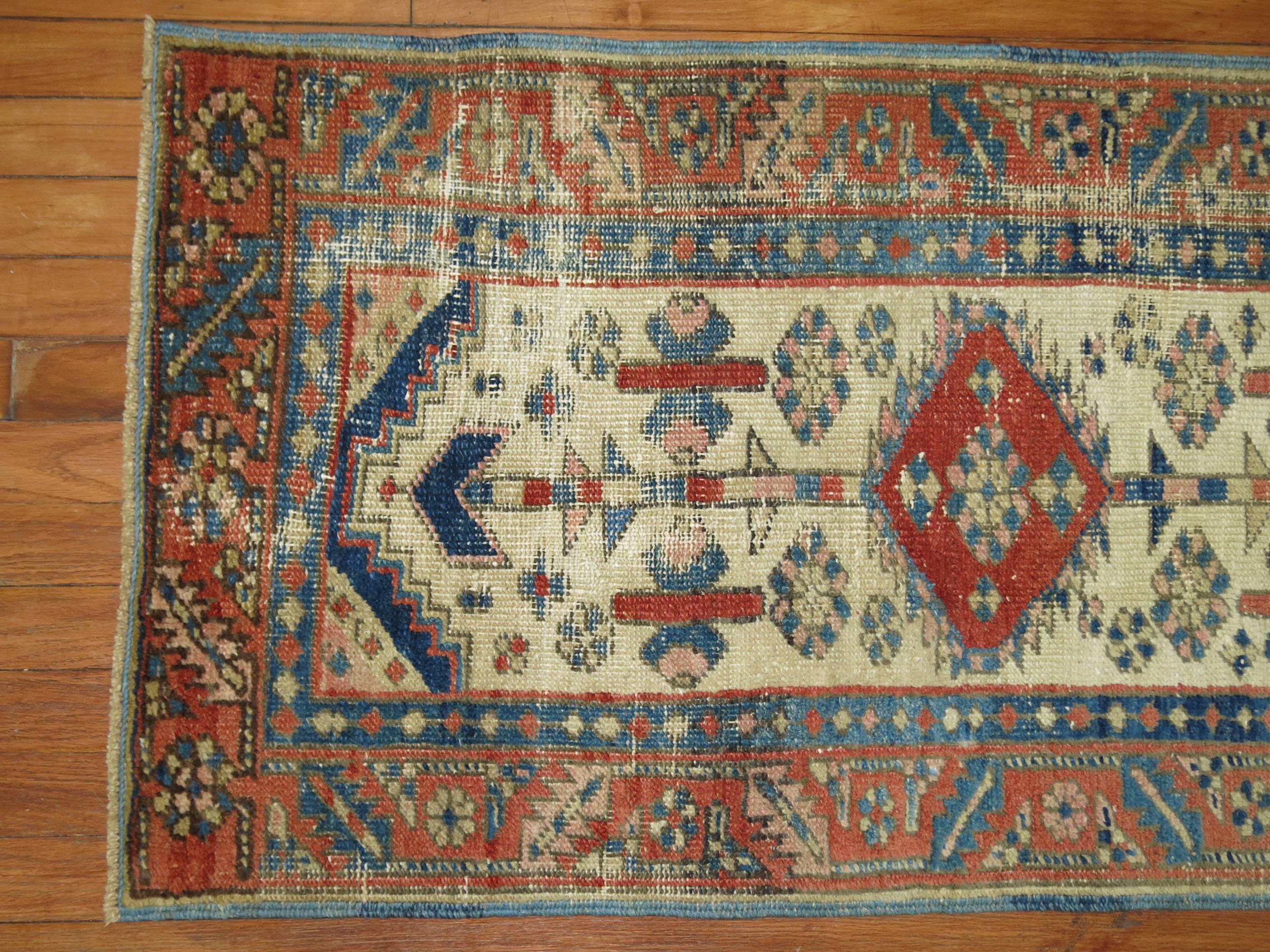 Authentic Persian Heriz throw rug with an ivory field.