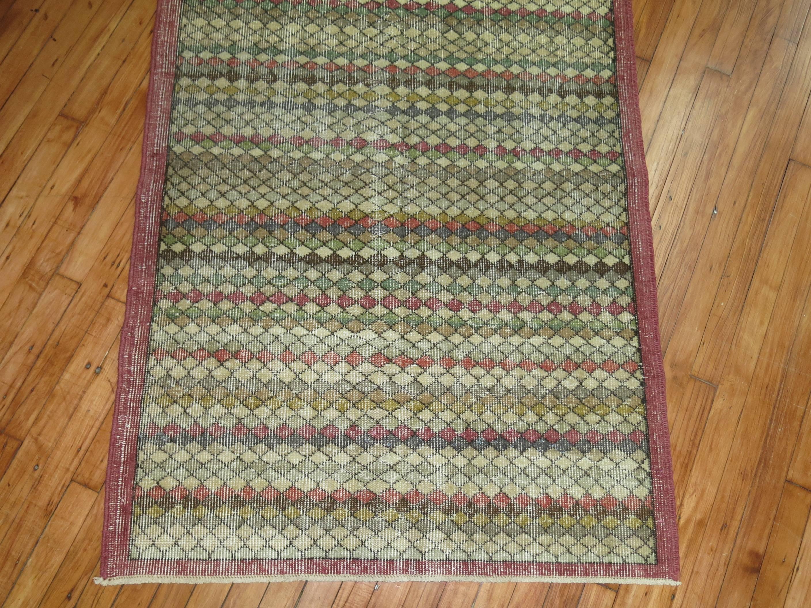 a fun small runner size mid 20th century Turkish Deco rug with a repetitive diamond motif throughout

3'6'' x 7'1''