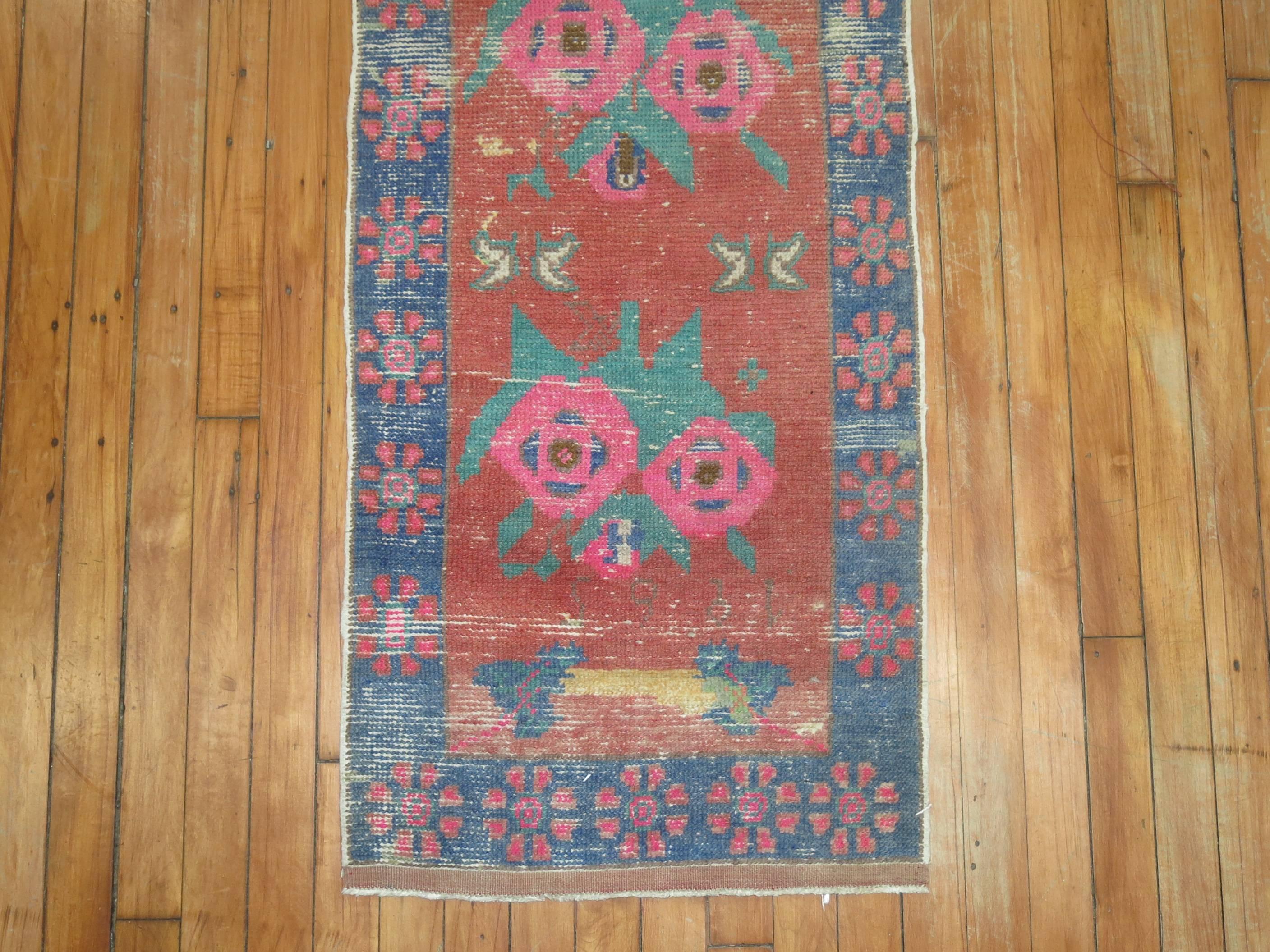 Mid-20th century turkish runner with an all over repetitive flower design. dated 1965

1'9'' x 9'1''