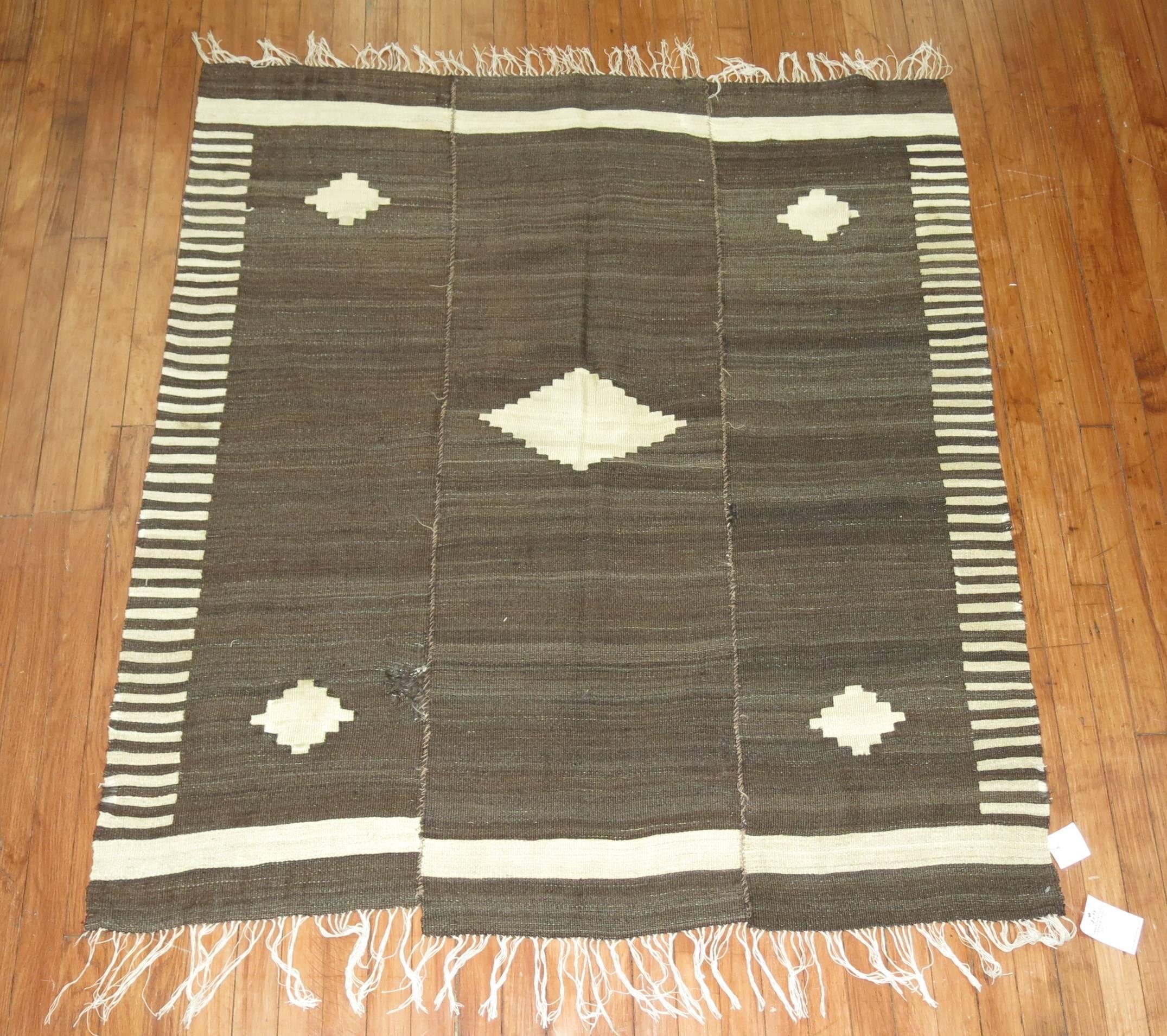 A turkish Kilim woven in 3 woven Panels. The left end intentionally woven shorter in length than the other 2 strips. Can be uses as a throw piece too.