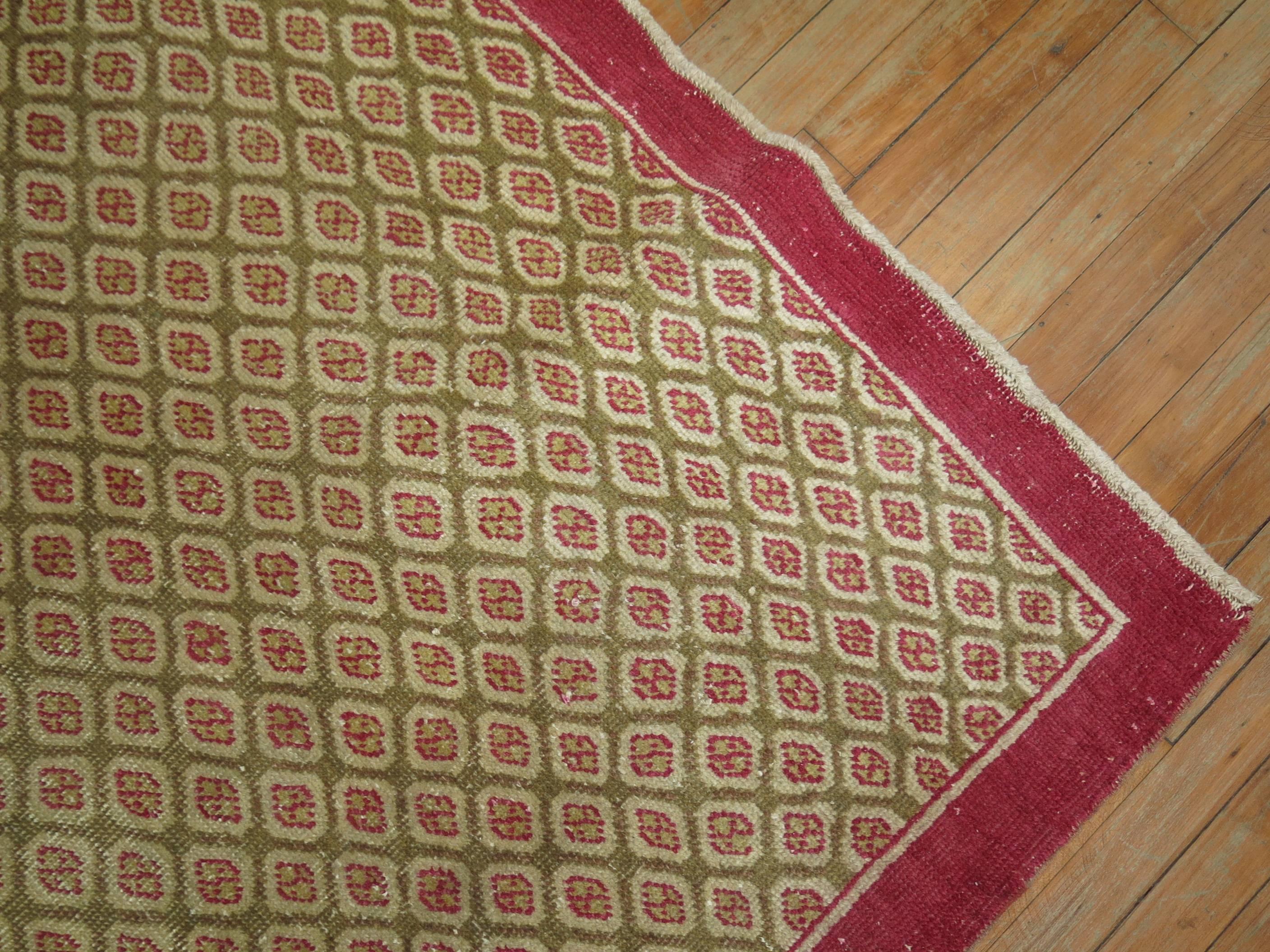 One of a kind vintage Turkish rug with a tight repetitive pattern in raspberries on a camel brown field.

4'1'' x 6'7''