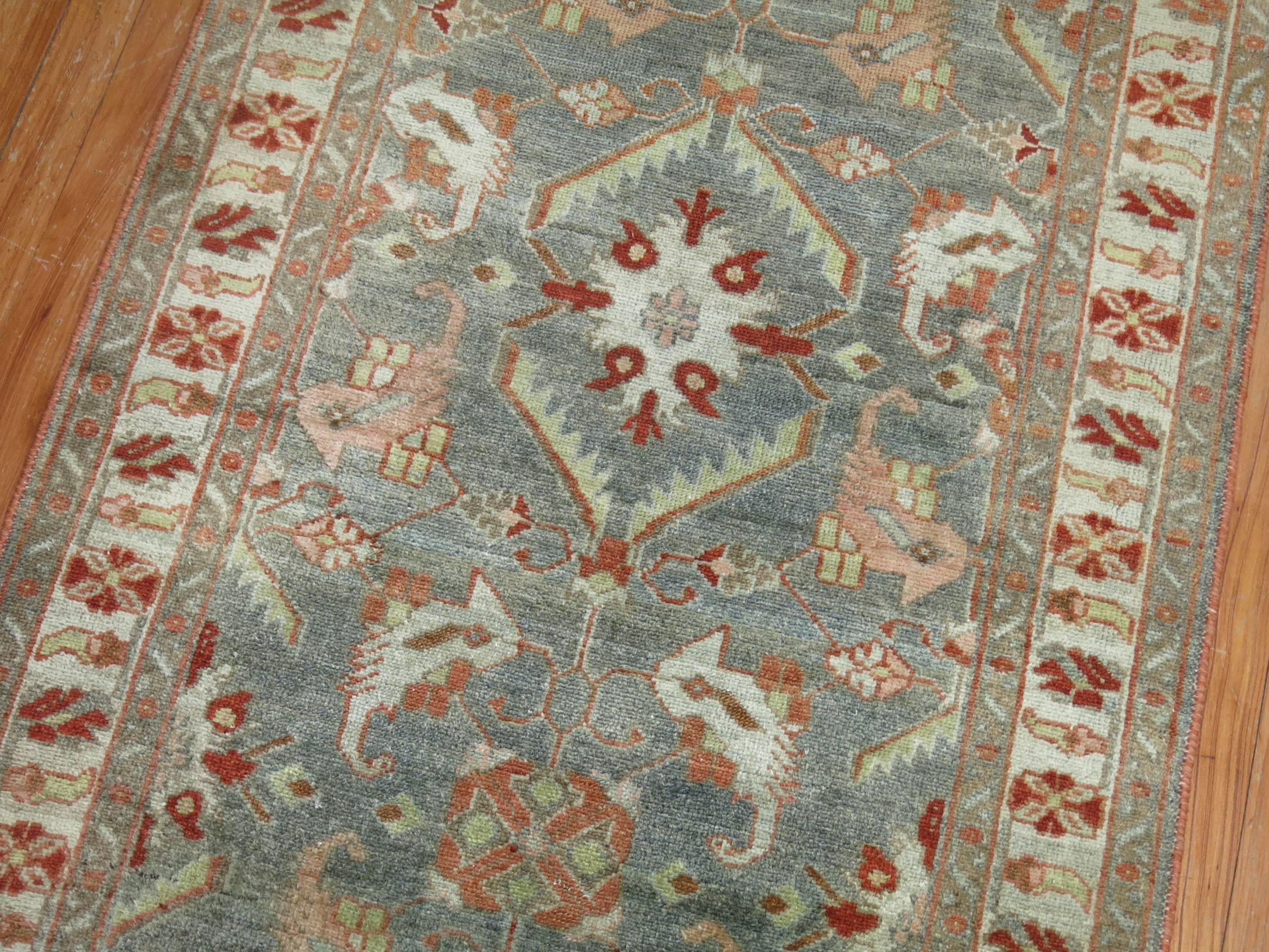 A long and narrow finely woven earth toned Persian Malayer runner.