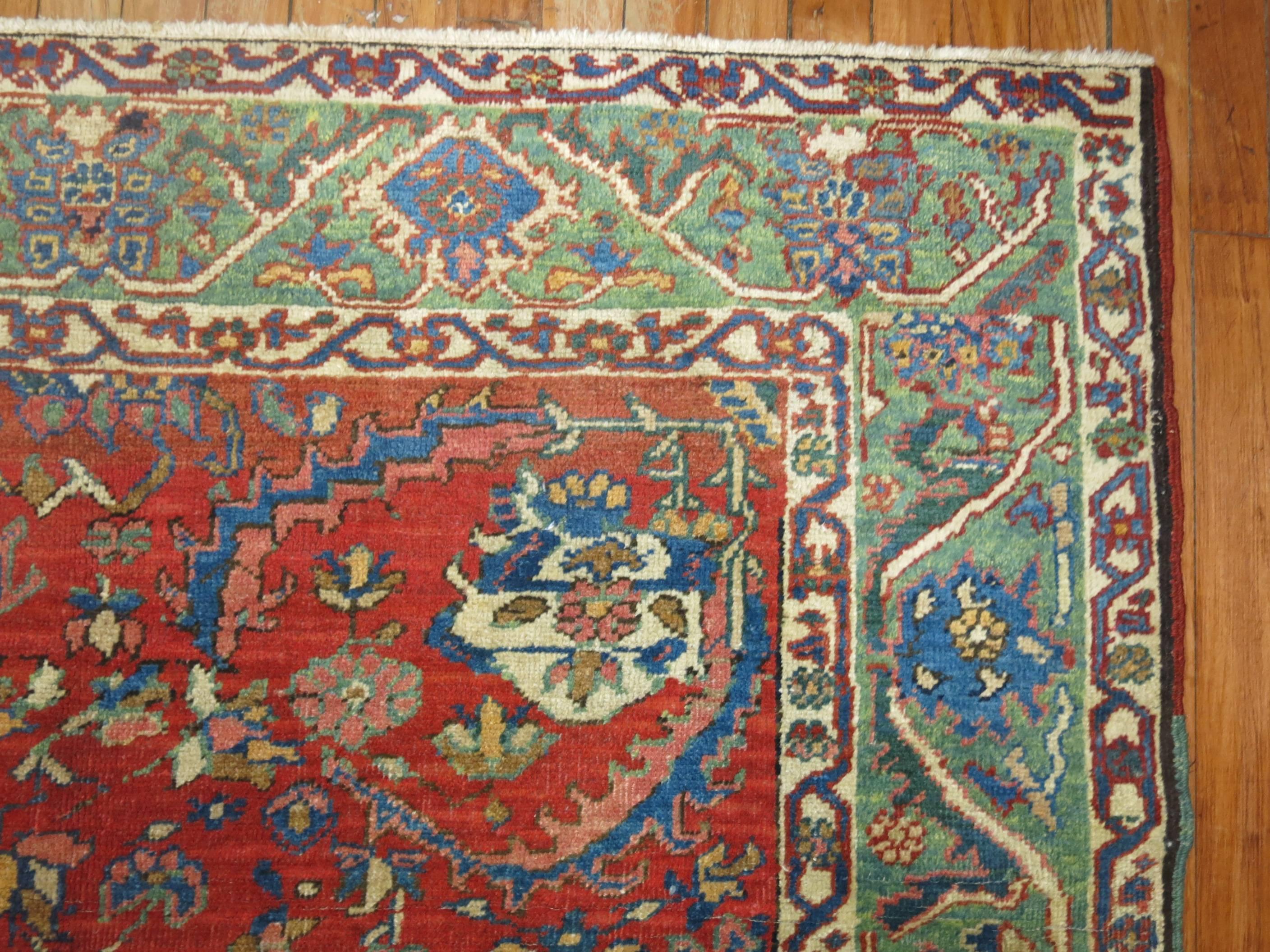 A colorful antique Persian Heriz rug with an orange-coral field and green border with accents in sky blue.

Measures: 4'10