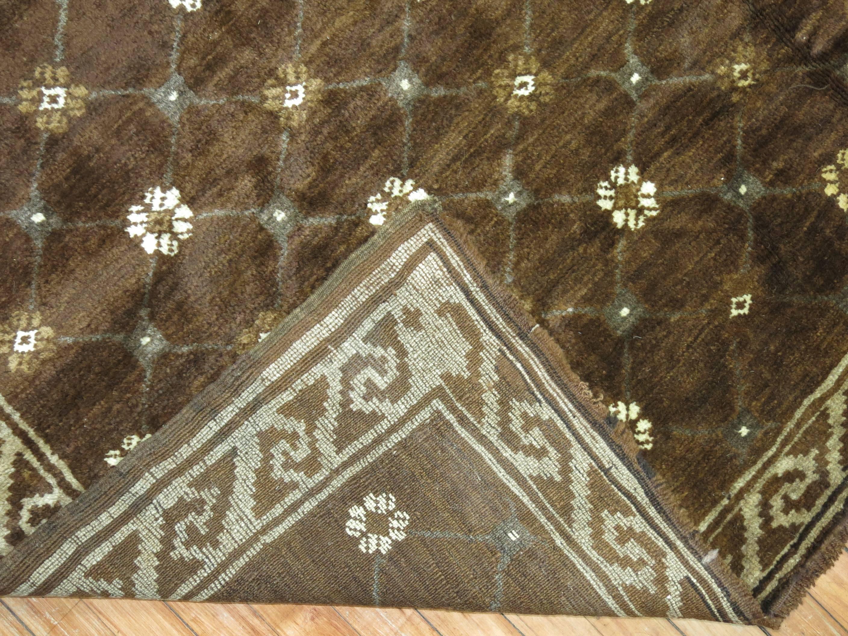A vintage midcentury Turkish rug having a contemporary design on a predominant chocolate brown background.

Measures: 6'9'' x 9'2''.