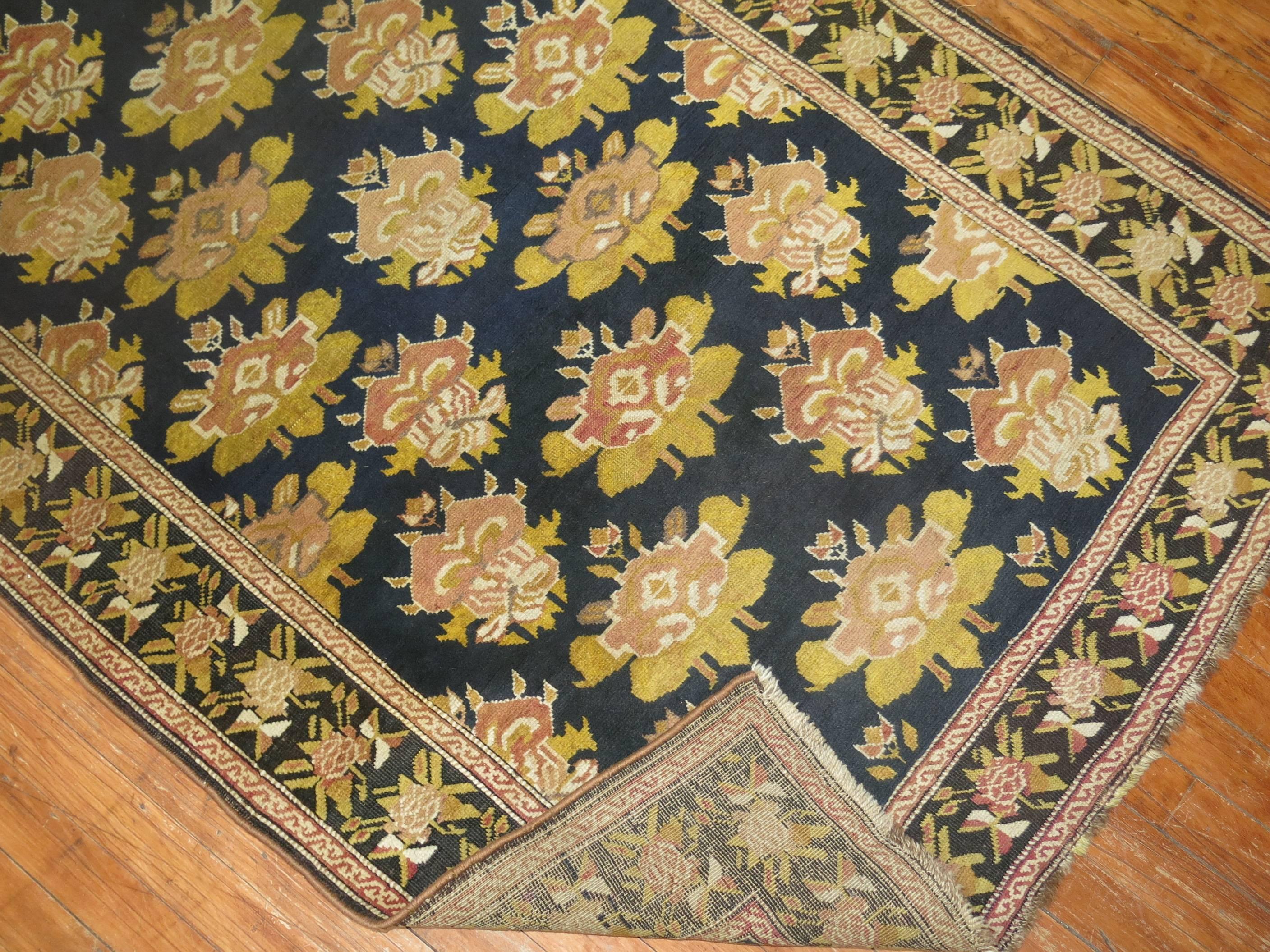 A very long early 20th century Russian Karabagh runner featuring accents in black, blue, gold and rust.
The border is black, the field is a deep navy blue. The quality is very fine.

Measures: 3'5