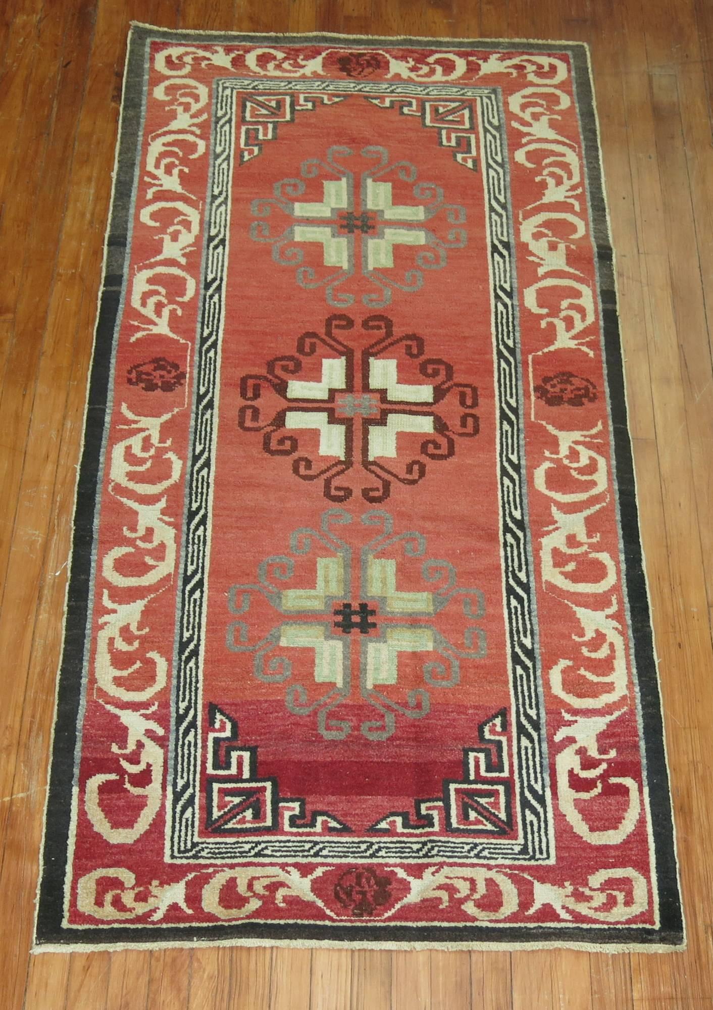 A one of a kind Turkish rug influenced by 19th century east Turkmenistan Khotan rugs.
3 round medallions on a rose ground, accents in brown, green, brown and gray accents, circa mid-20th century.

Measures: 3'2