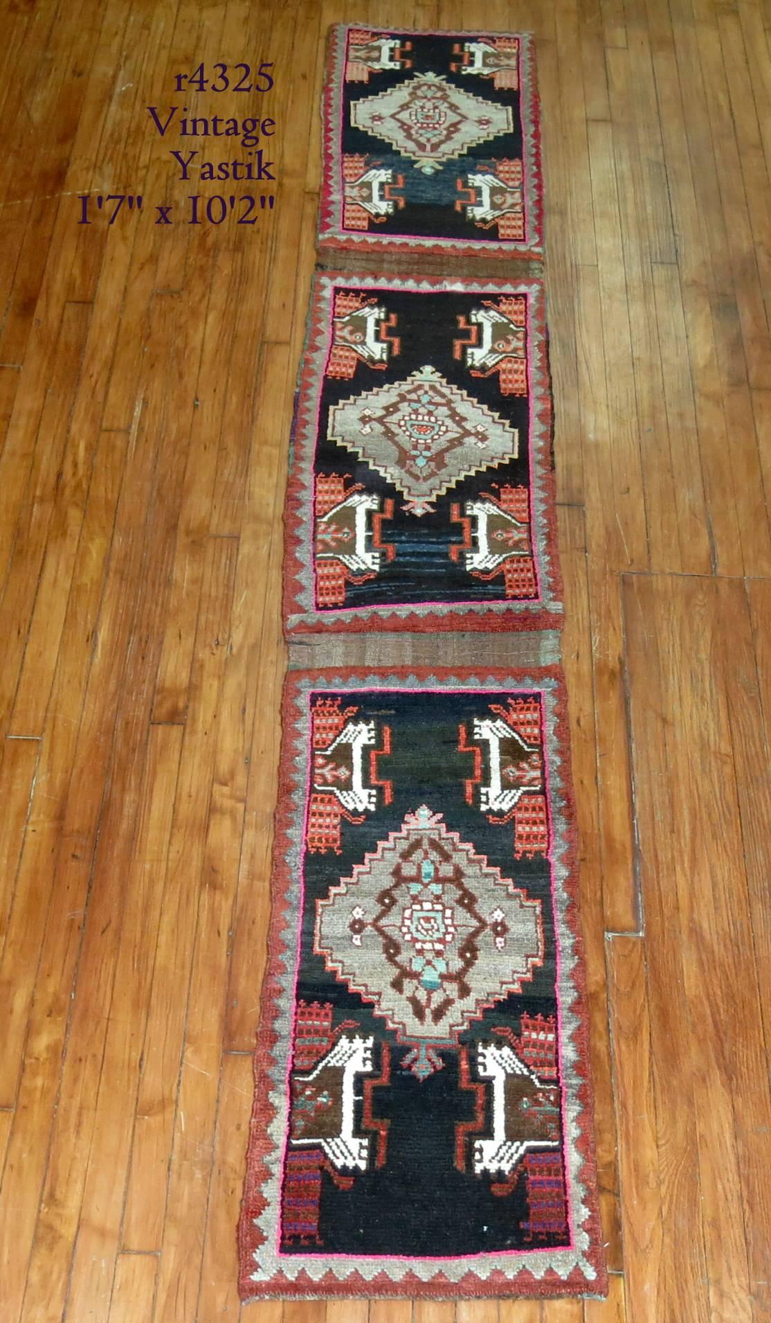 A rare narrow size eclectic vintage Turkish runner in predominant accents in black, pink and orange.