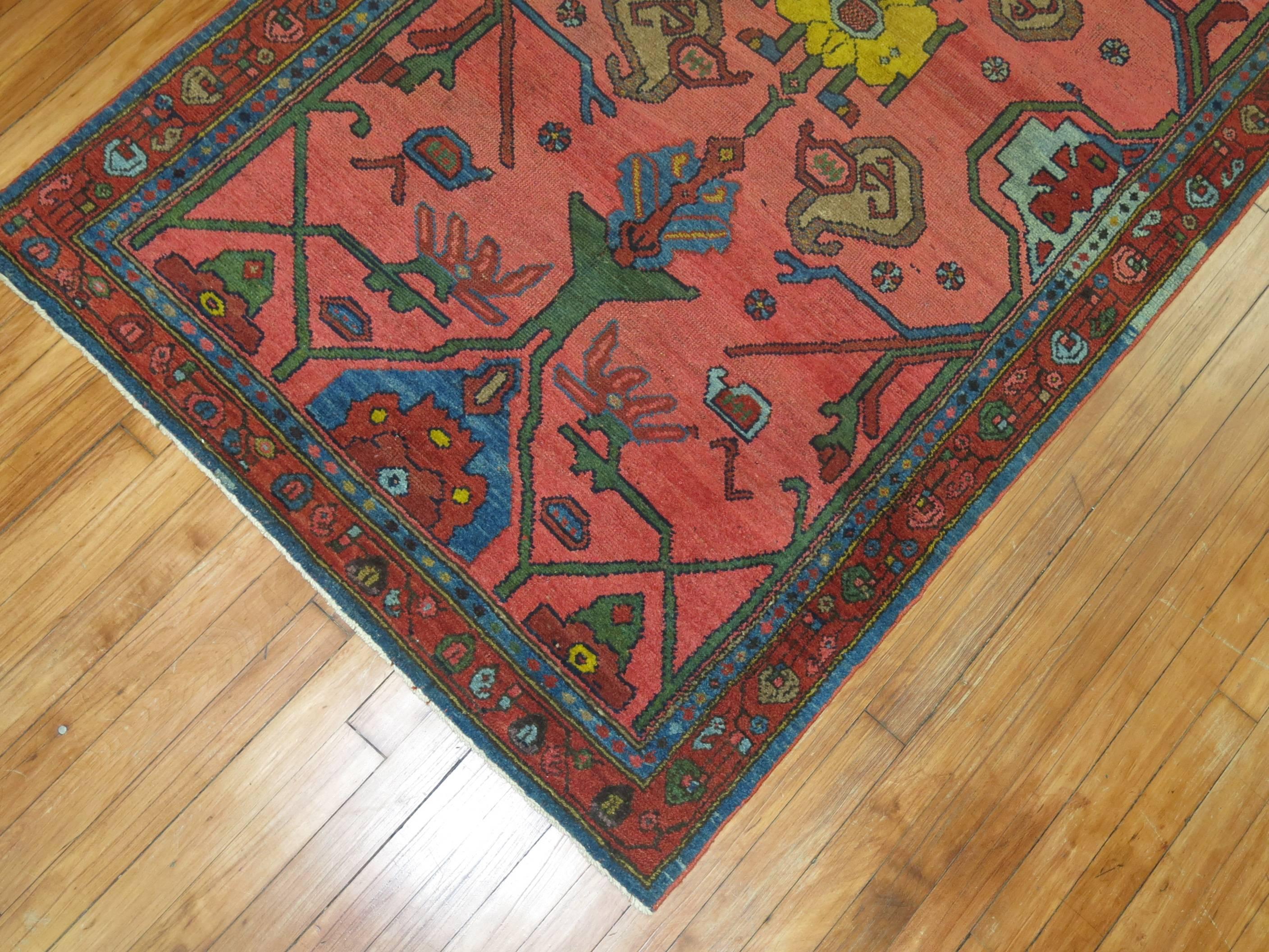 A colorful circa 1930 Persian rug from central Persia with blue, green, brown and yellow accents 

Measures: 3'6'' x 6'4''.