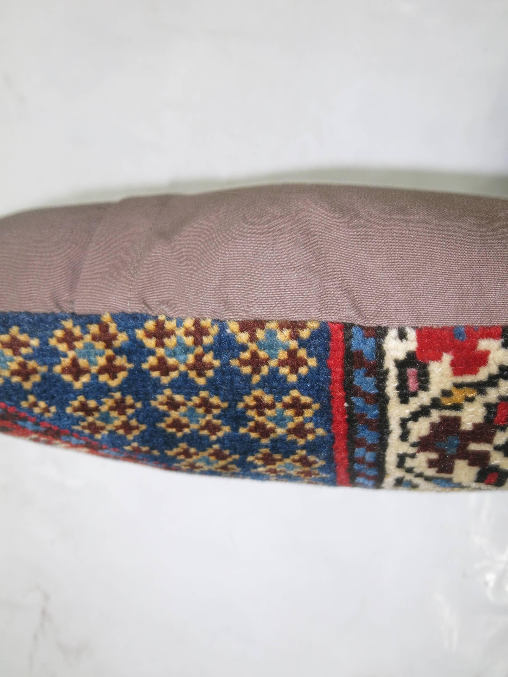 Pillow made from a 19th century Kazak rug in traditional Red, blue and brown accents.

Measures: 18