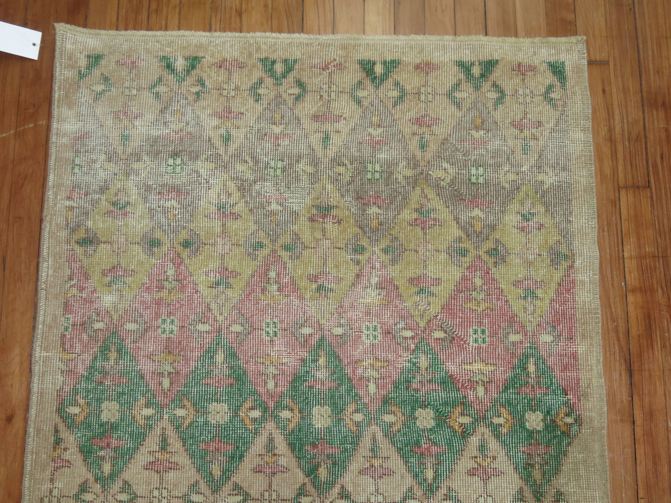 Vintage Anatolian runner with repetitive diamond motif throughout in gray, cream, pink and beige accents.

Measures: 3'3