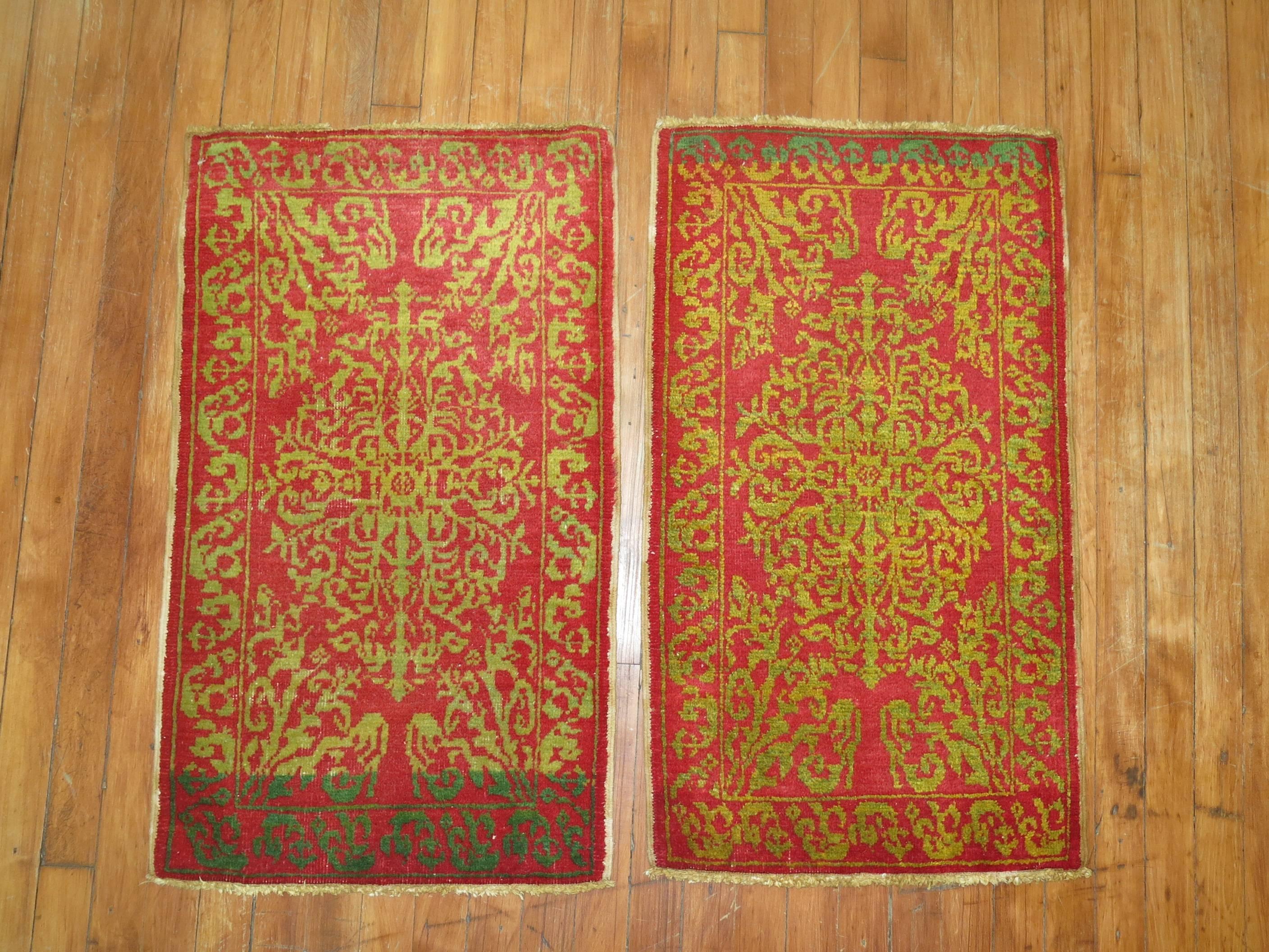 A set of finely woven Turkish rugs in bright reds and greens.