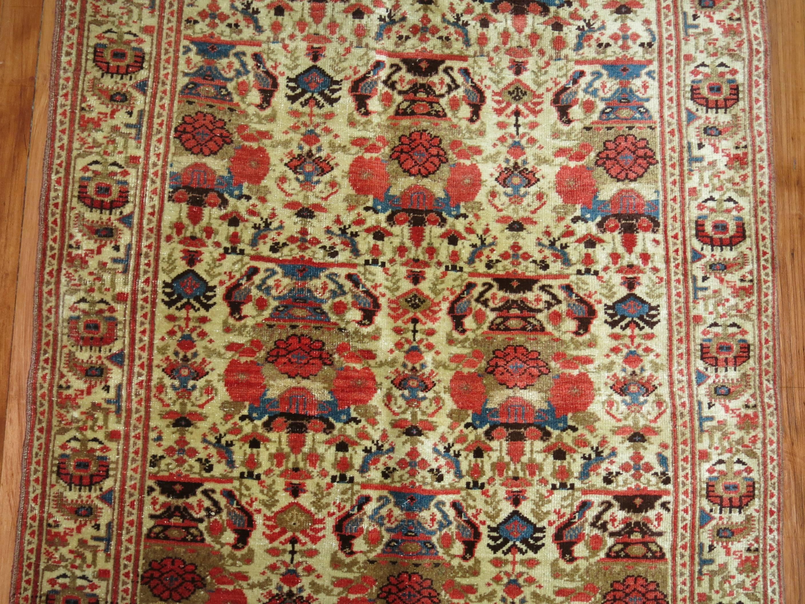 An exquisite Persian Malayer runner with an all-over floral design surrounded by an elaborate floral border.