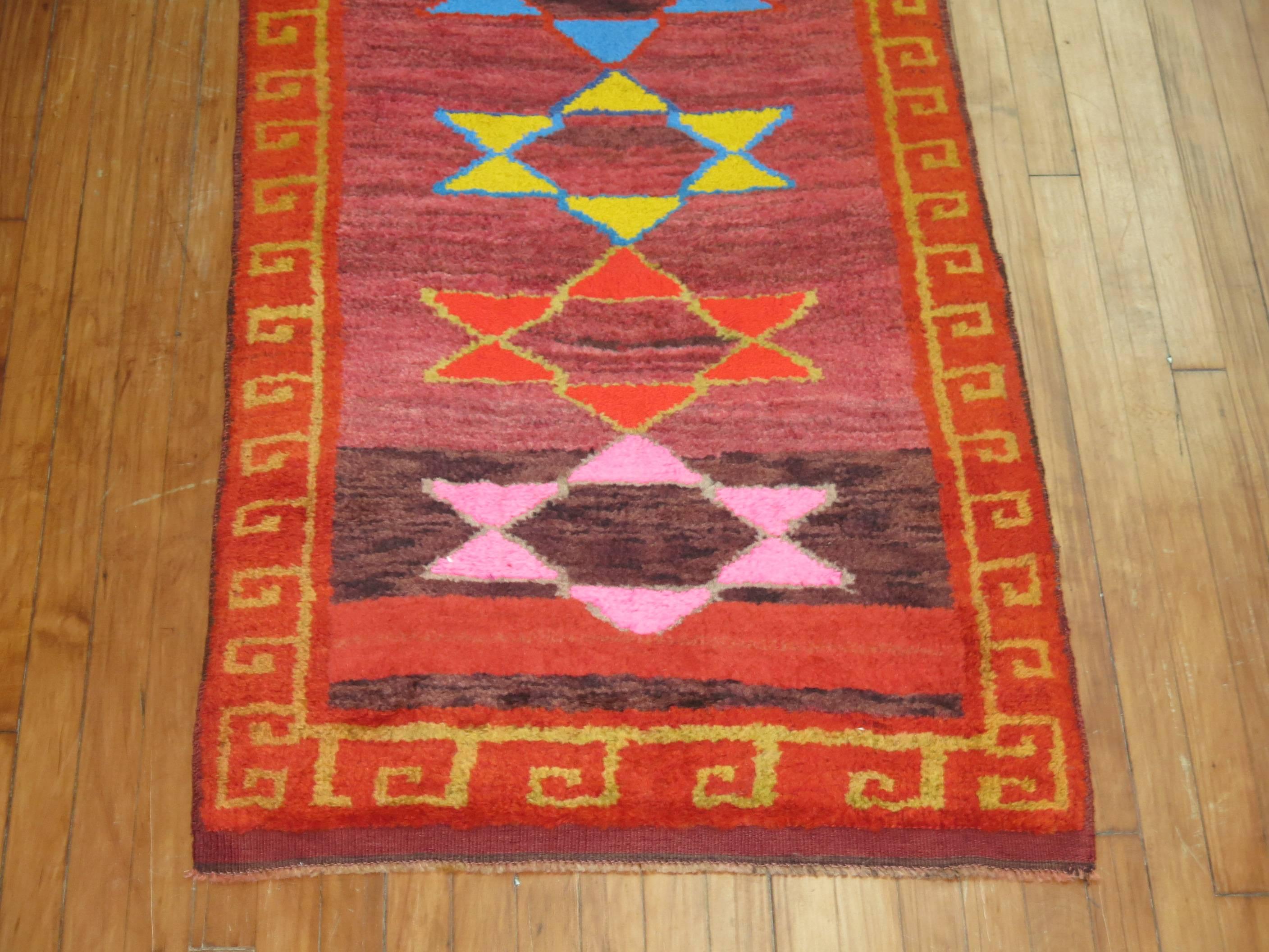 Mid-20th century Turkish runner with a bright all-over star motif. So many wild colors predominantly in bright pink, lavender, electric blue, coral and red.

Measures: 2'9