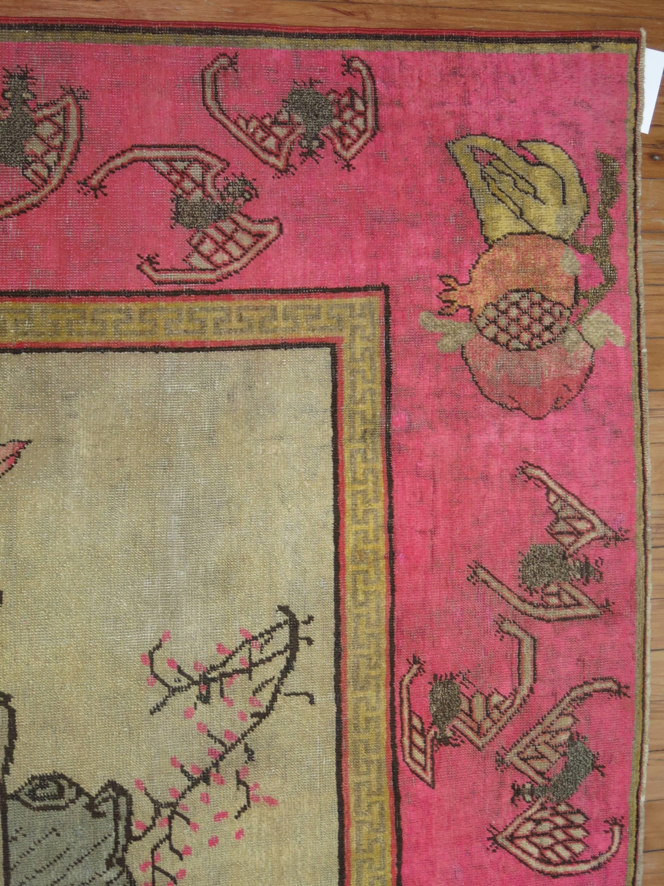 East Turkestani Antique Pictorial Khotan Rug with Bright Pink Border