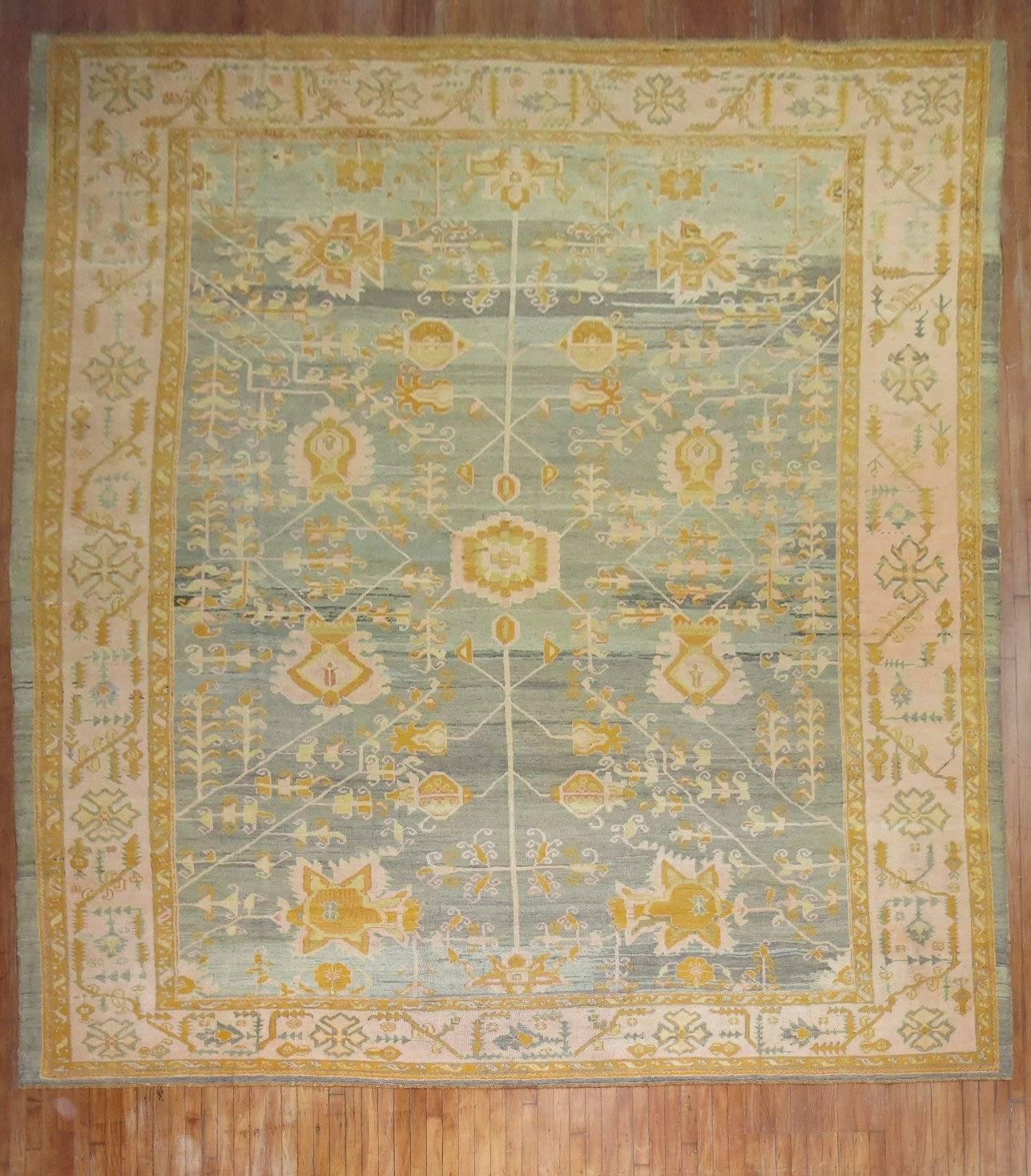 A phenomenal late 19th century antique Oushak rug in pinks, corals, blues, greens and gold.

Measures: 12' x 15'8''

Antique oriental carpets and rugs from Oushak have been carefully chosen as highly esteemed objects in important European homes.