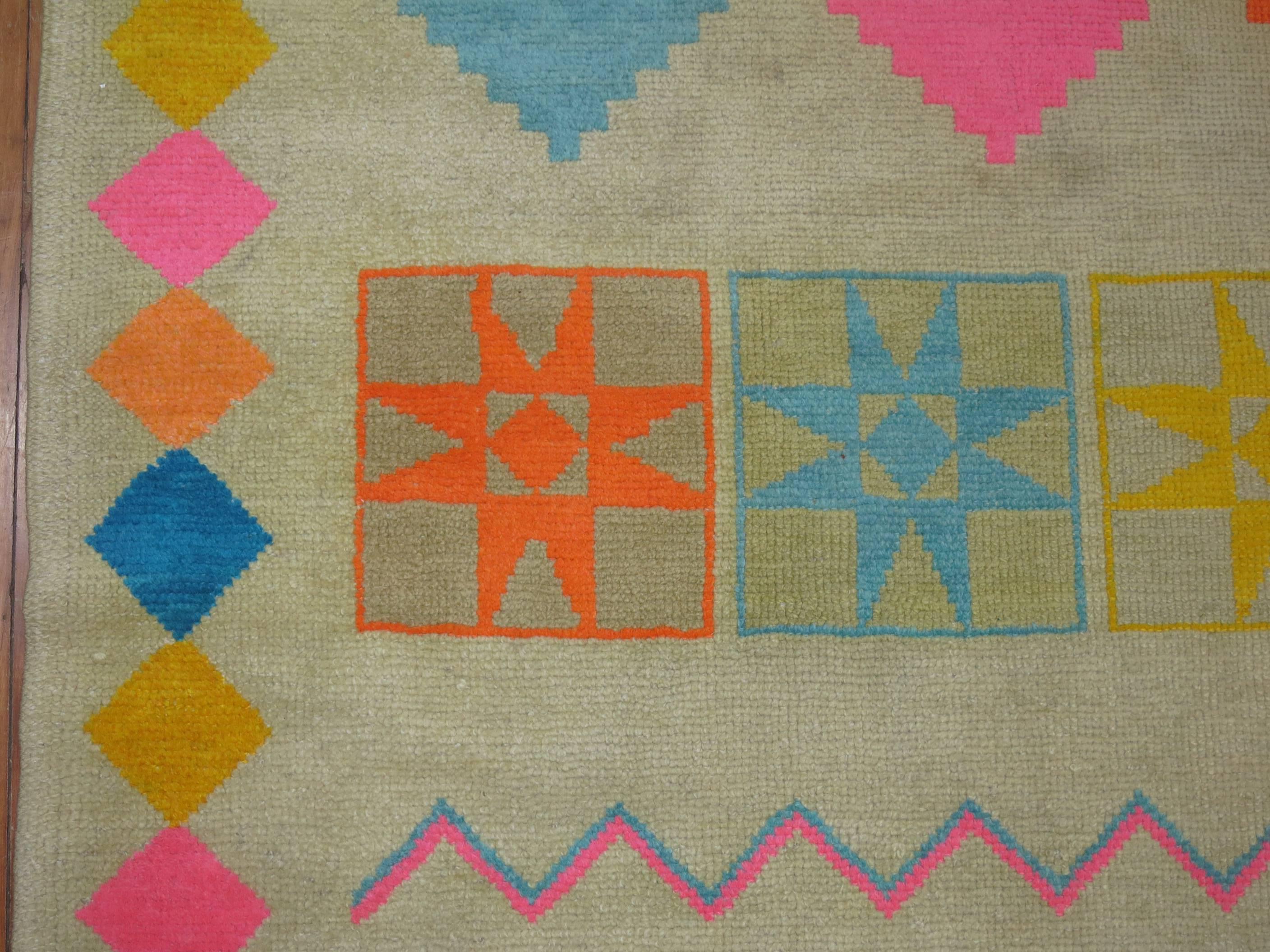 A dynamic colored one of a kind mid-20th century Turkish rug accents in bright pink, orange, blues. We have never seen this design in any rug to this day and its definitely one of our favorite finds in a very long time. 