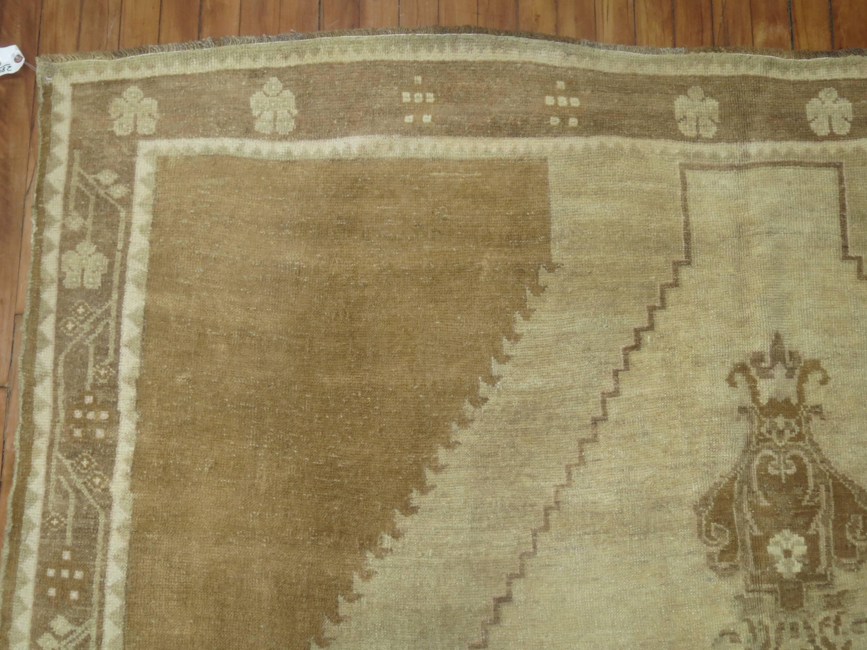 Turkish Kars in browns and khaki with an elegant open field central medallion design.

6'7'' x 10'2''