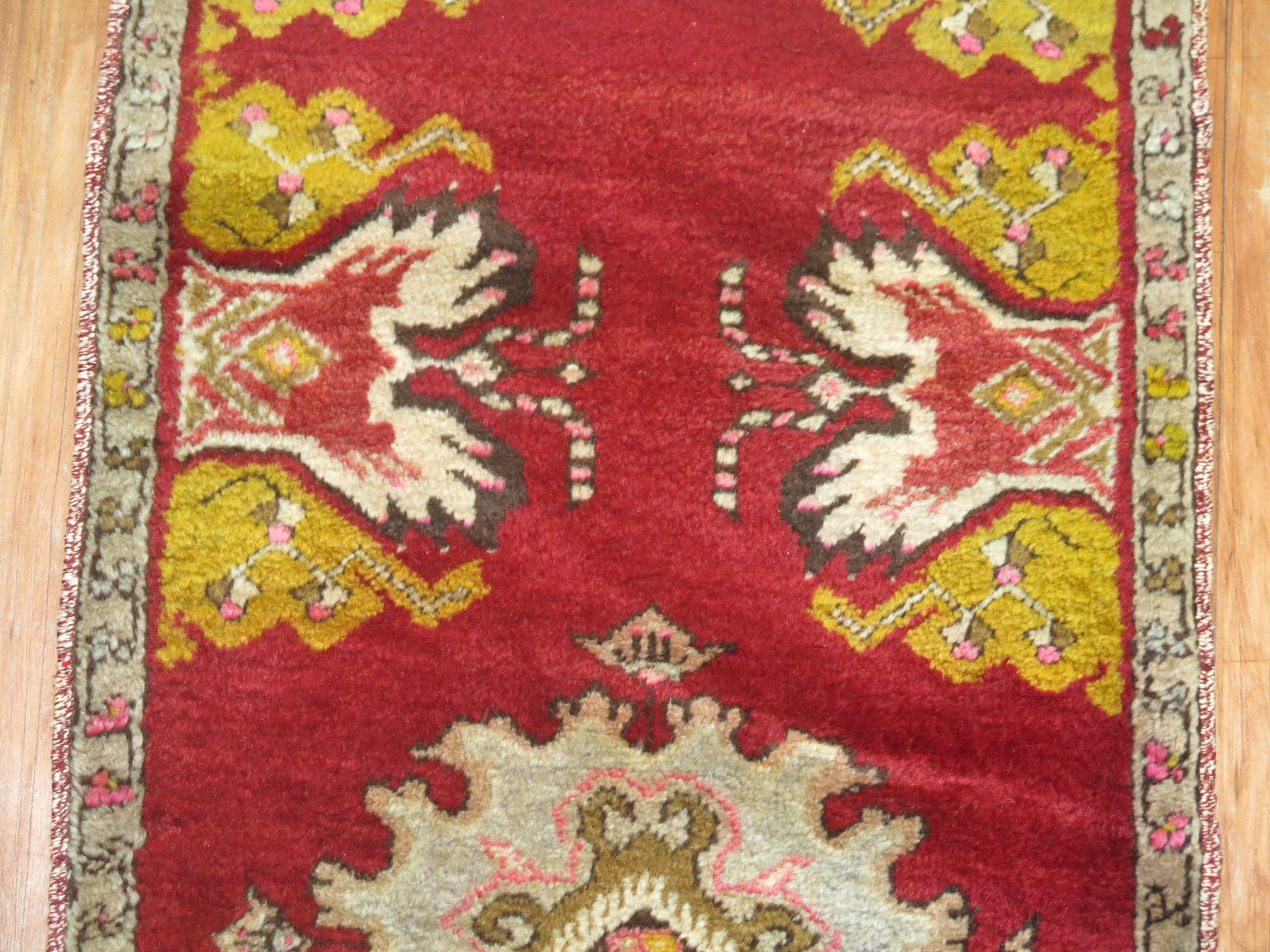 A narrow vintage turkish runner in predominant bright cherry red.