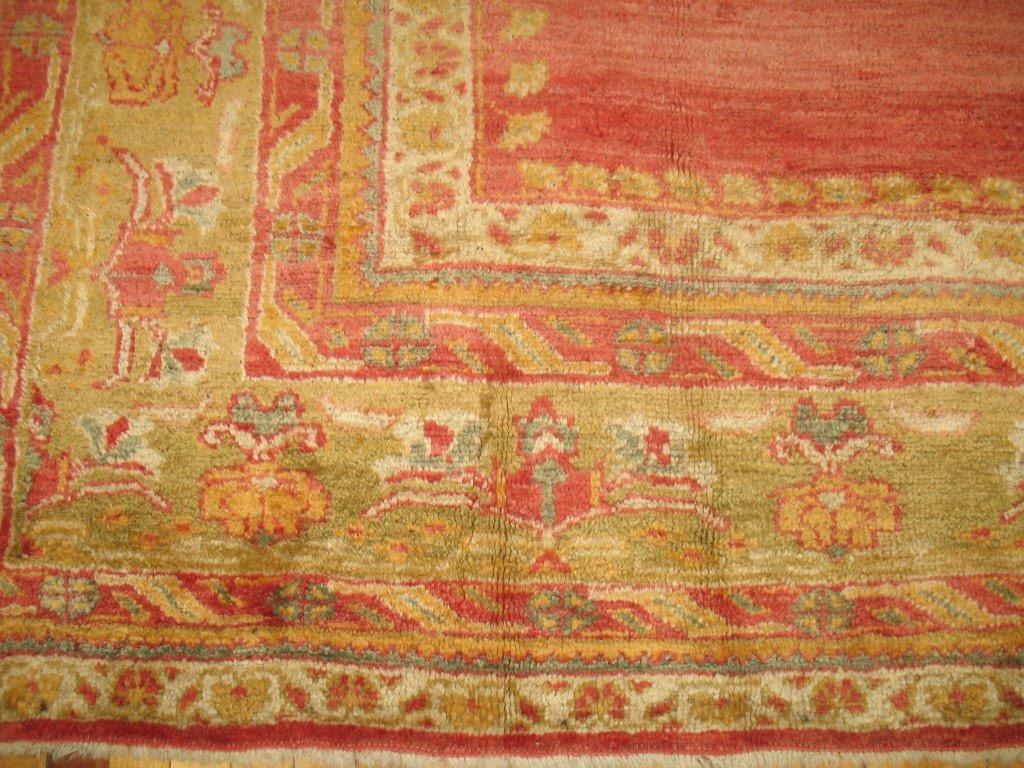 One of our finest Antique Turkish Oushaks we have in our entire collection that we purchased from an estate in Westhampton, NY. Contains a rosy red field with a soft green medallion and main border with accent colors in cream, honey and apricot. The