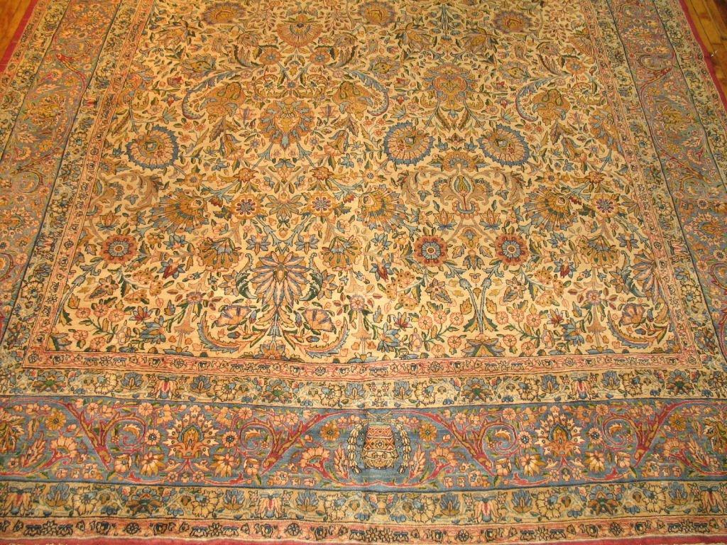 A beautiful over-sized floral Persian carpet woven in the city of Kerman towards the latter stages of the 19th century. Splendid jewel tone colors and fine weave make this one of our best Antique Persian rugs we have in stock. Priced at an
