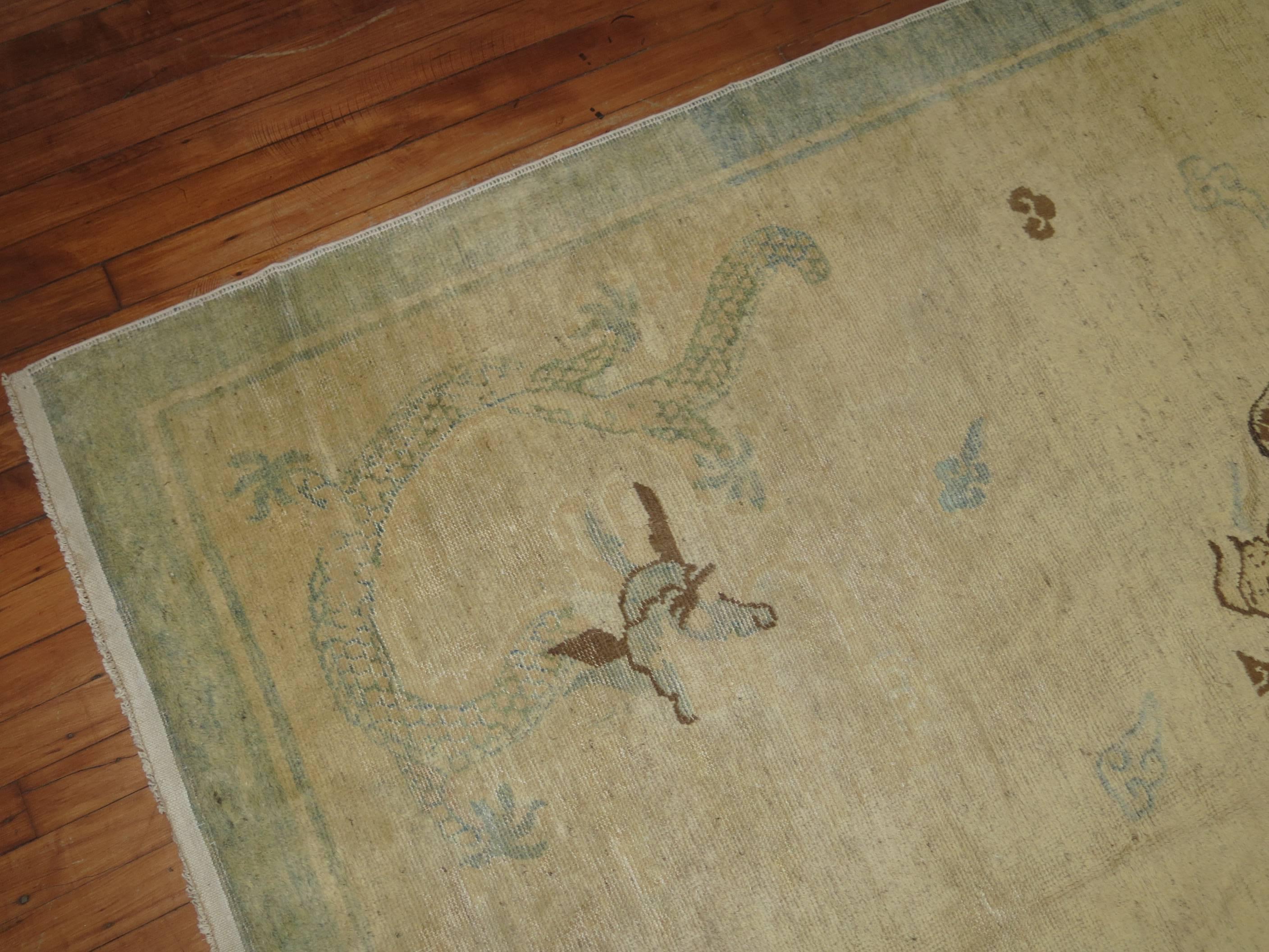 Beautiful Chinese Peking rug with a dragon medallion motif on an ivory colored field and soft baby blue border. Size is uncommon for its type.