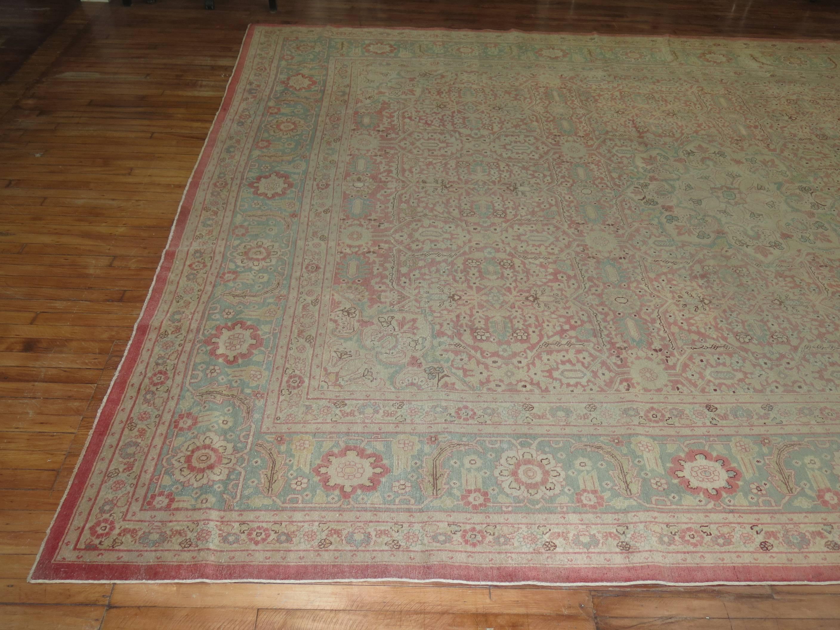 An early 20th-century Indian Amritsar rug woven with the finest of quality and wool. The medallion is almost forgotten due to the busy elements in the field and border. Predominant color accents consist in pink, peach, and mint green.

Measures:
