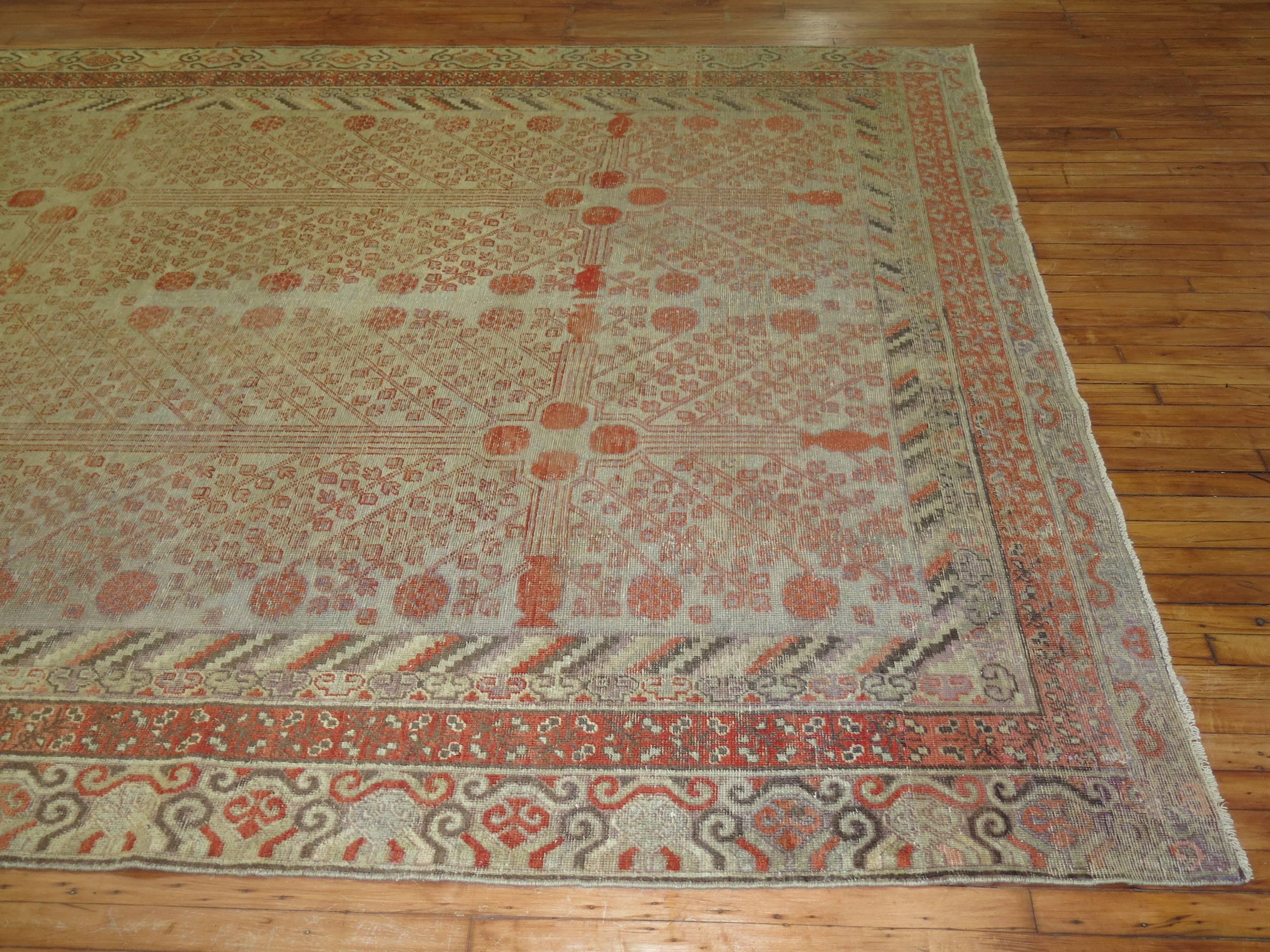 Rare size antique Khotan rug with shabby chic appeal. The field is gray, accents in soft red and brown. The pomegranate design is infamous from this region,

circa 1880. Measures: 8'1