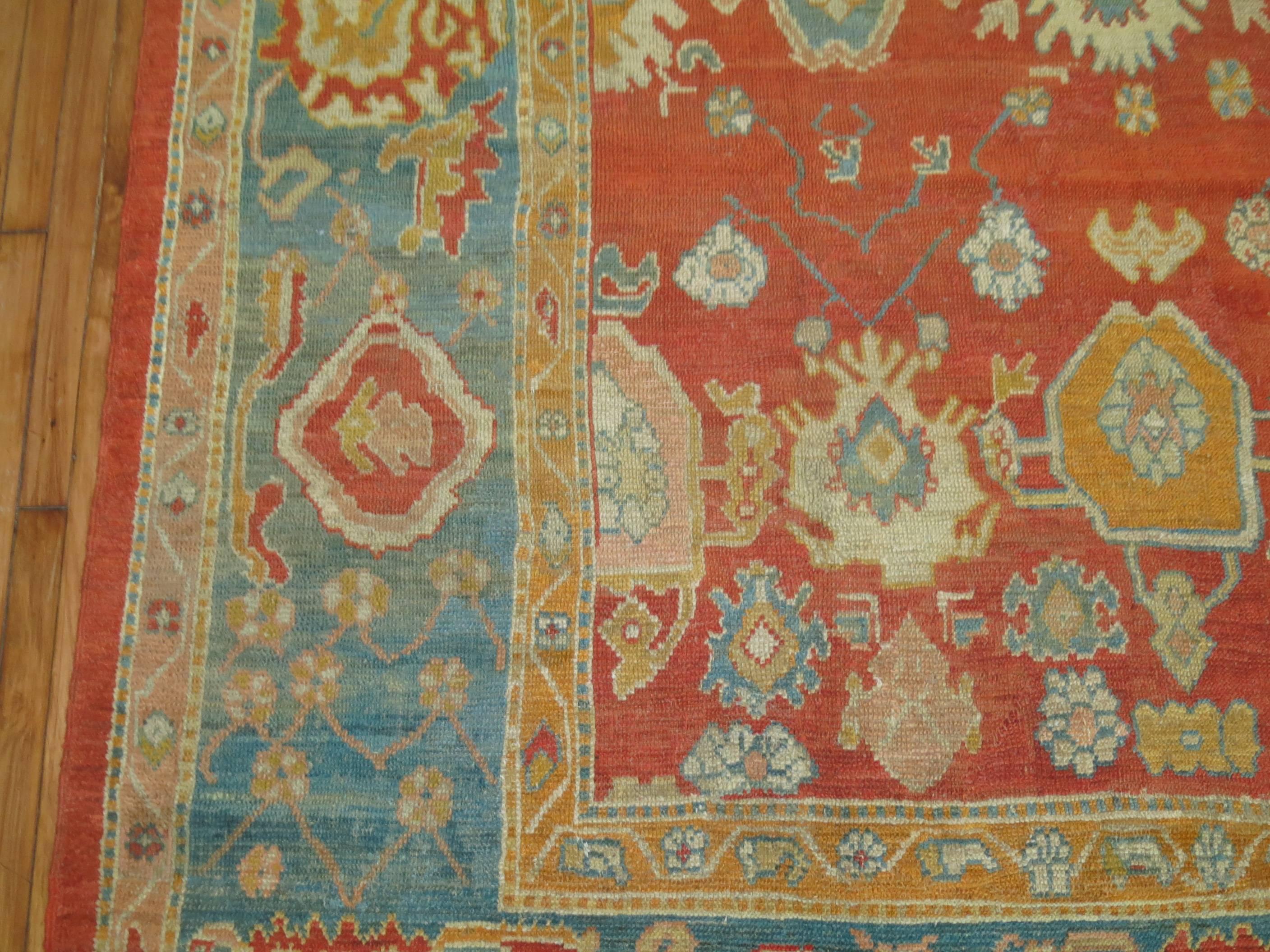 An absolute stunning one of a kind old Oushak with bright and cheerful colors. Coral red field, teal border with gold, ivory and terracotta color shades. A very fun rug to decorate around,

circa 1890-1900. Measures: 8'5'' x 11'6''.