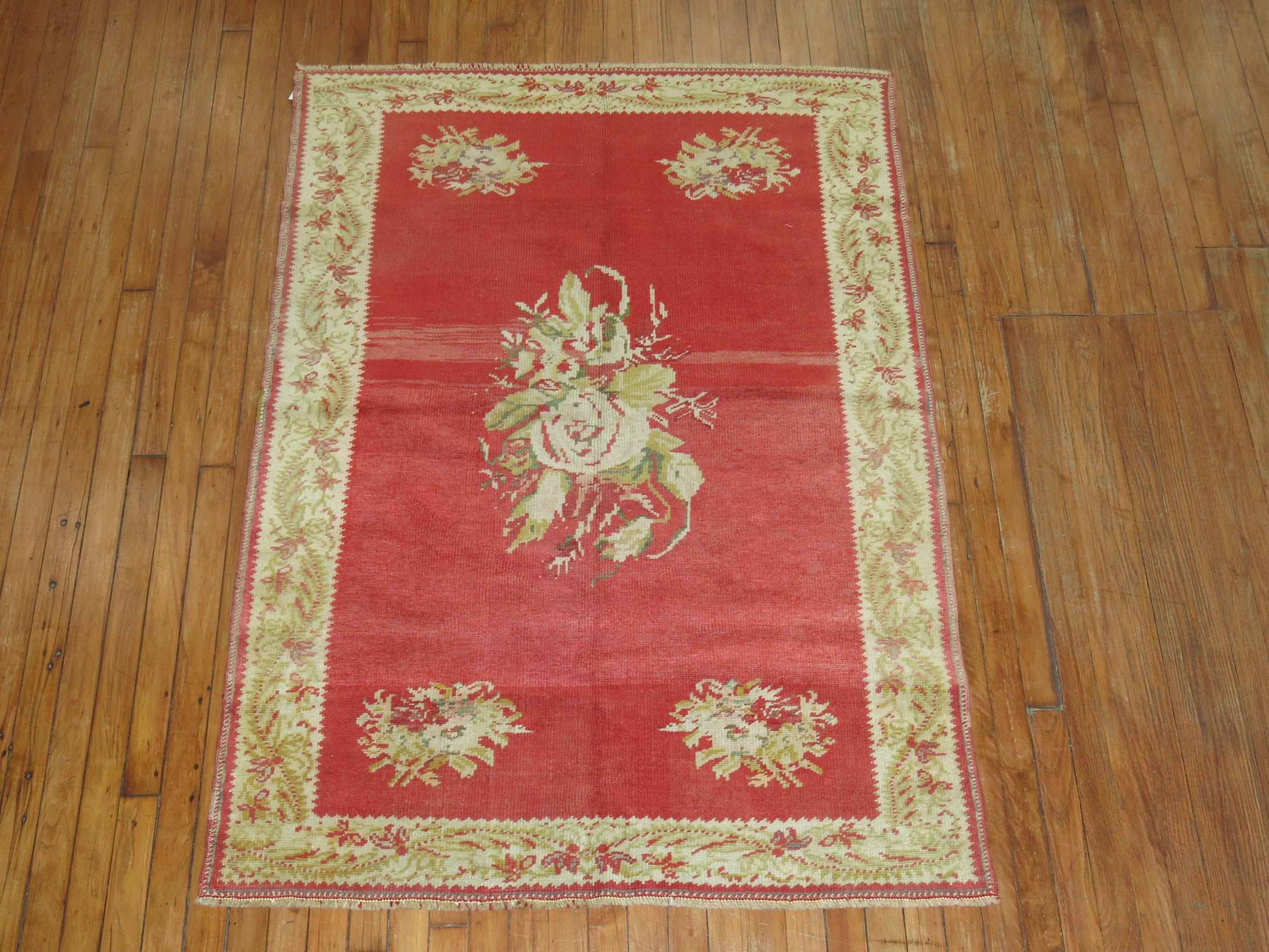 An elegant floral Turkish Ghiordes rug with flower bouquets running through a strawberry red ground and tan border. 

Measures: 3'10