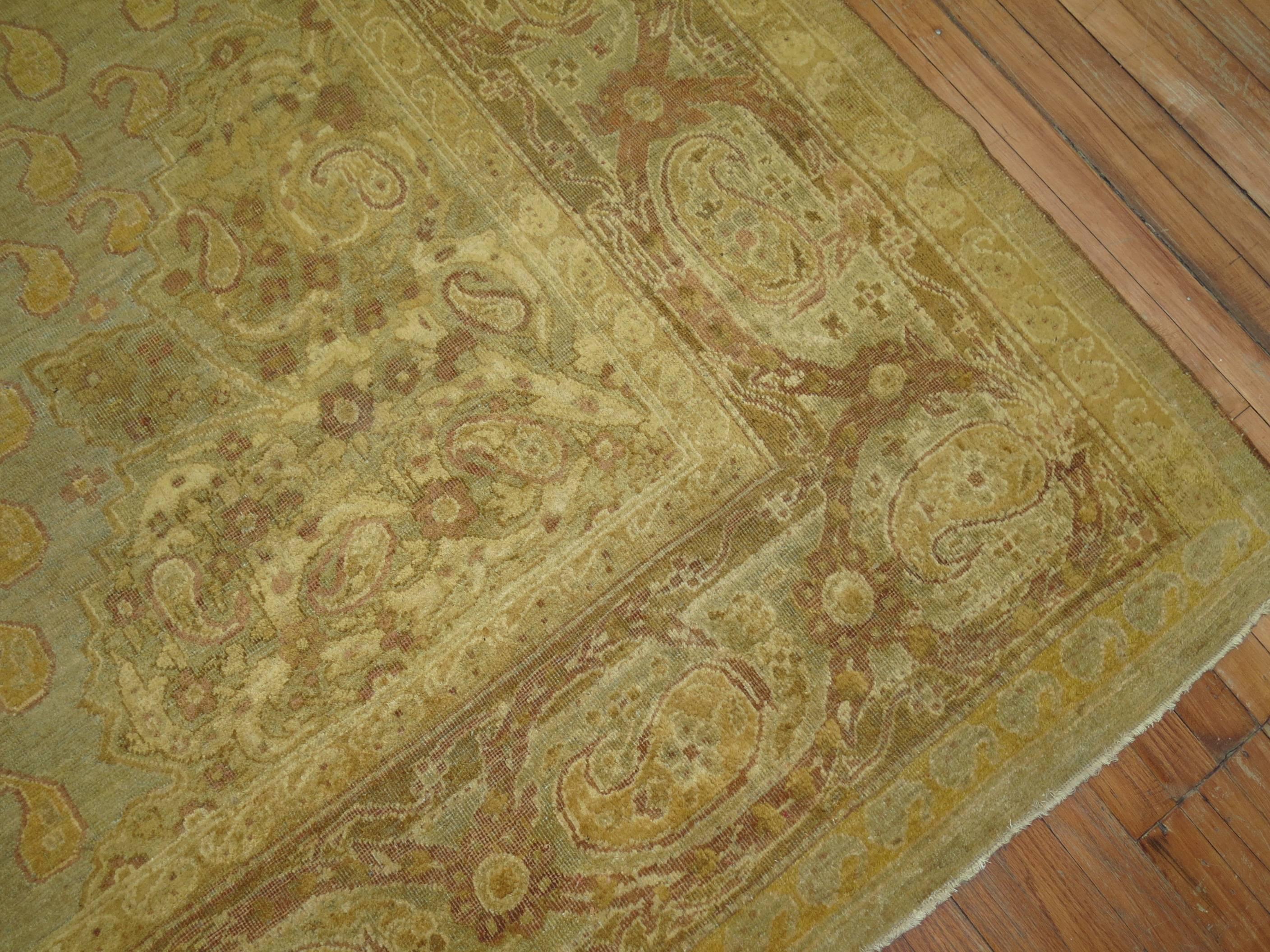 A stellar late 19th century Agra carpet with slate gold, brown and lavender shades with a gorgeous central medallion and lovely boteh's surfacing in the field. 

Measures: 9'10