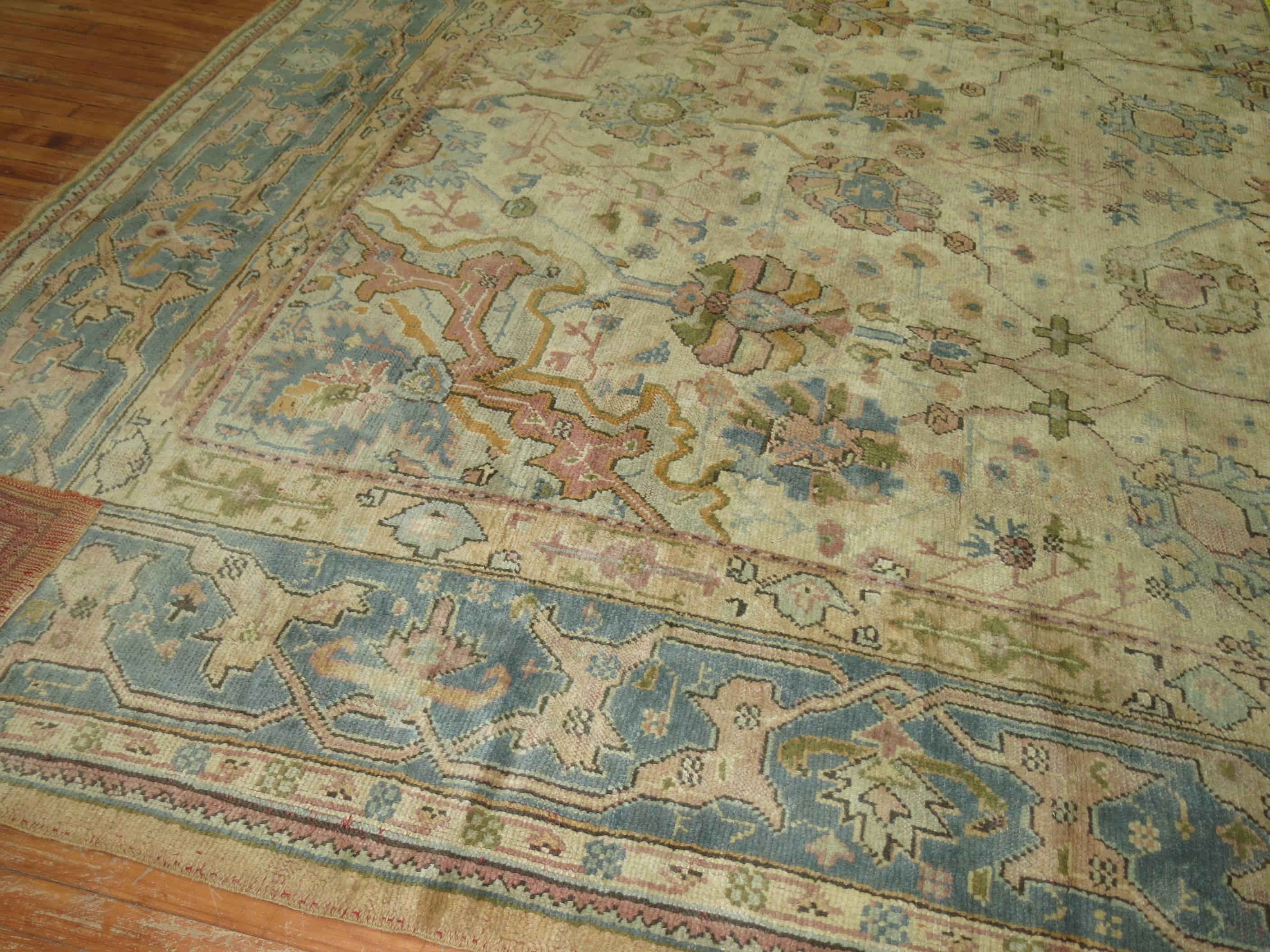 A lovely antique Turkish Oushak rug with warm earth tones, all-over.