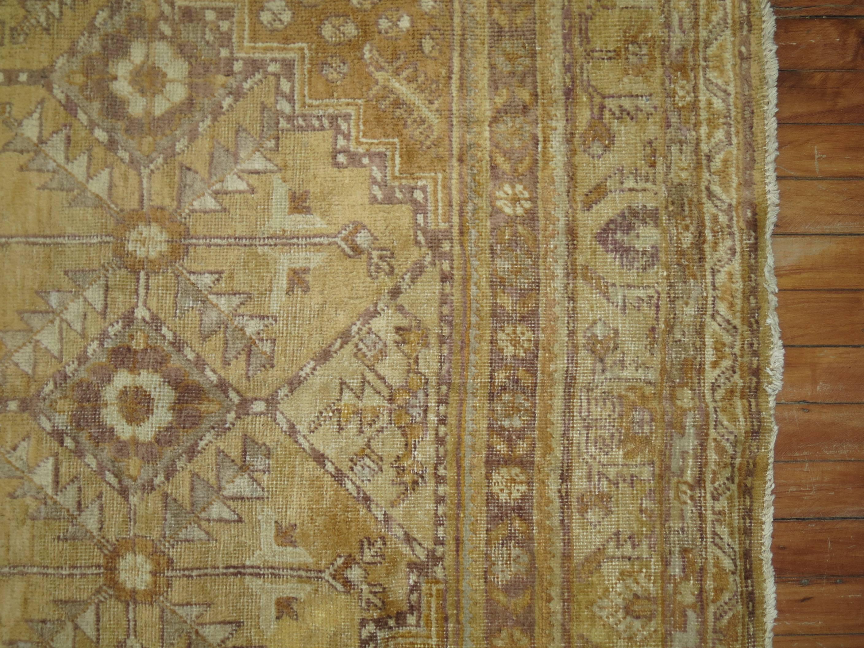 Khotan gallery rug with nice all-over geometric palette in a predominant straw color. Outline colors in ivory and brown

Size: 6'10