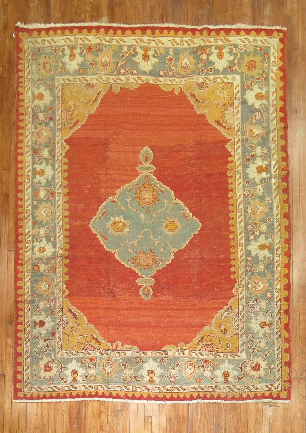 A pleasant antique Turkish Oushak brilliantly done in a tomato red ground, sage green border and central medallion with White and bronze color accents included.

7'3'' x 10'