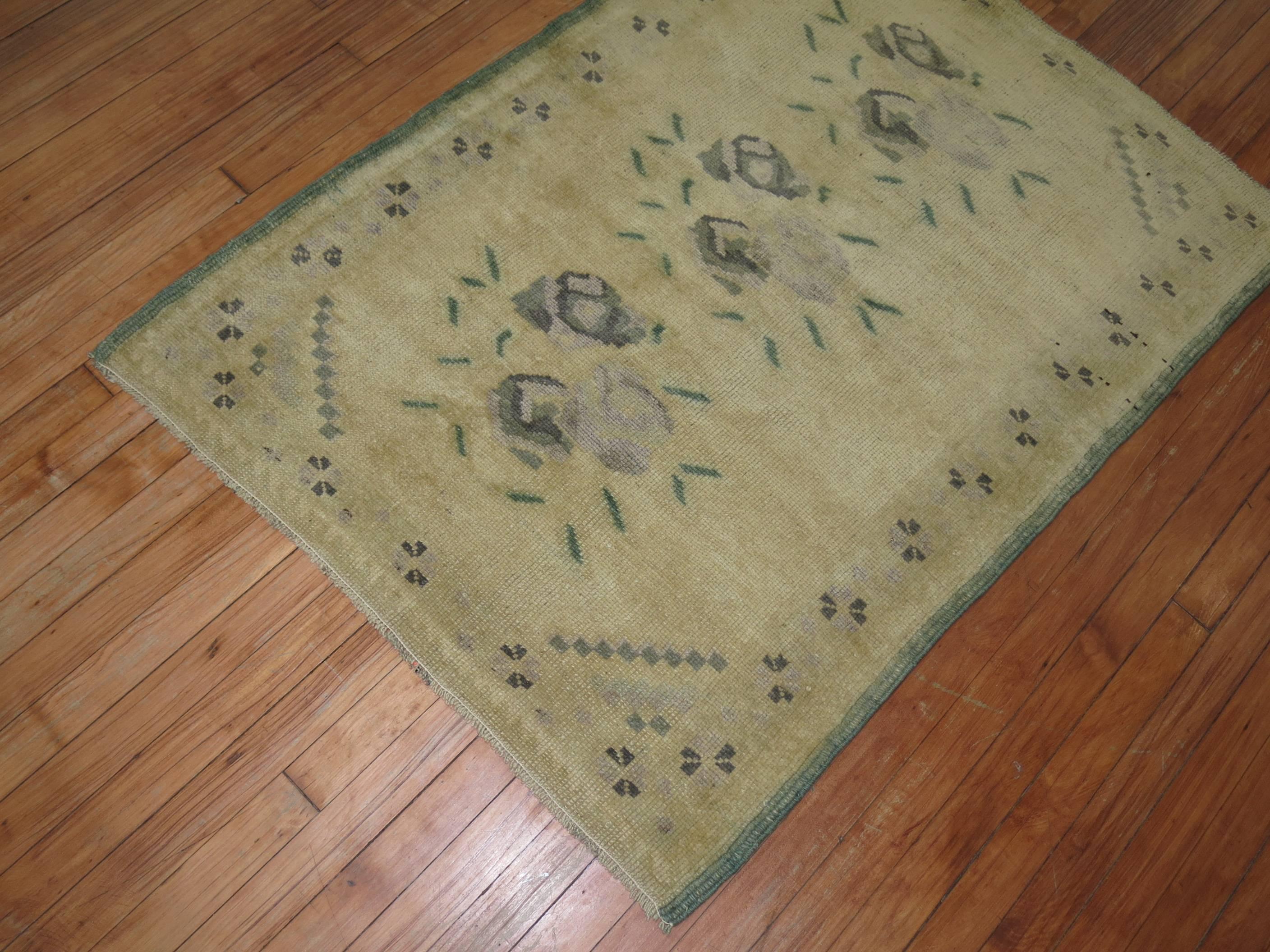 A Mid-Century Turkish rug with an intricate floral motif on a beige ground.