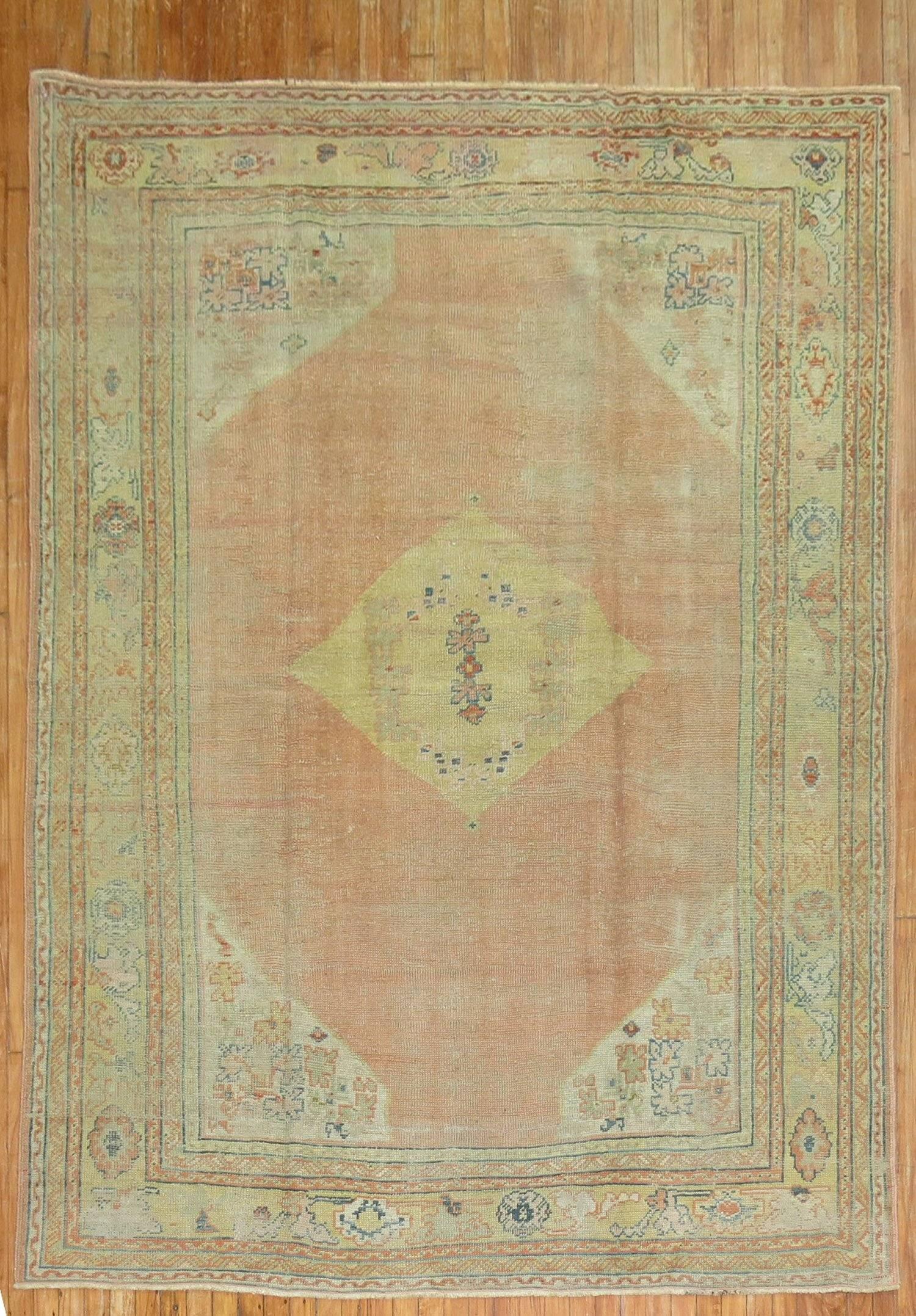 Authentic one of a kind handmade Turkish Oushak rug with a soft orange colored field and yellow medallion and border. 