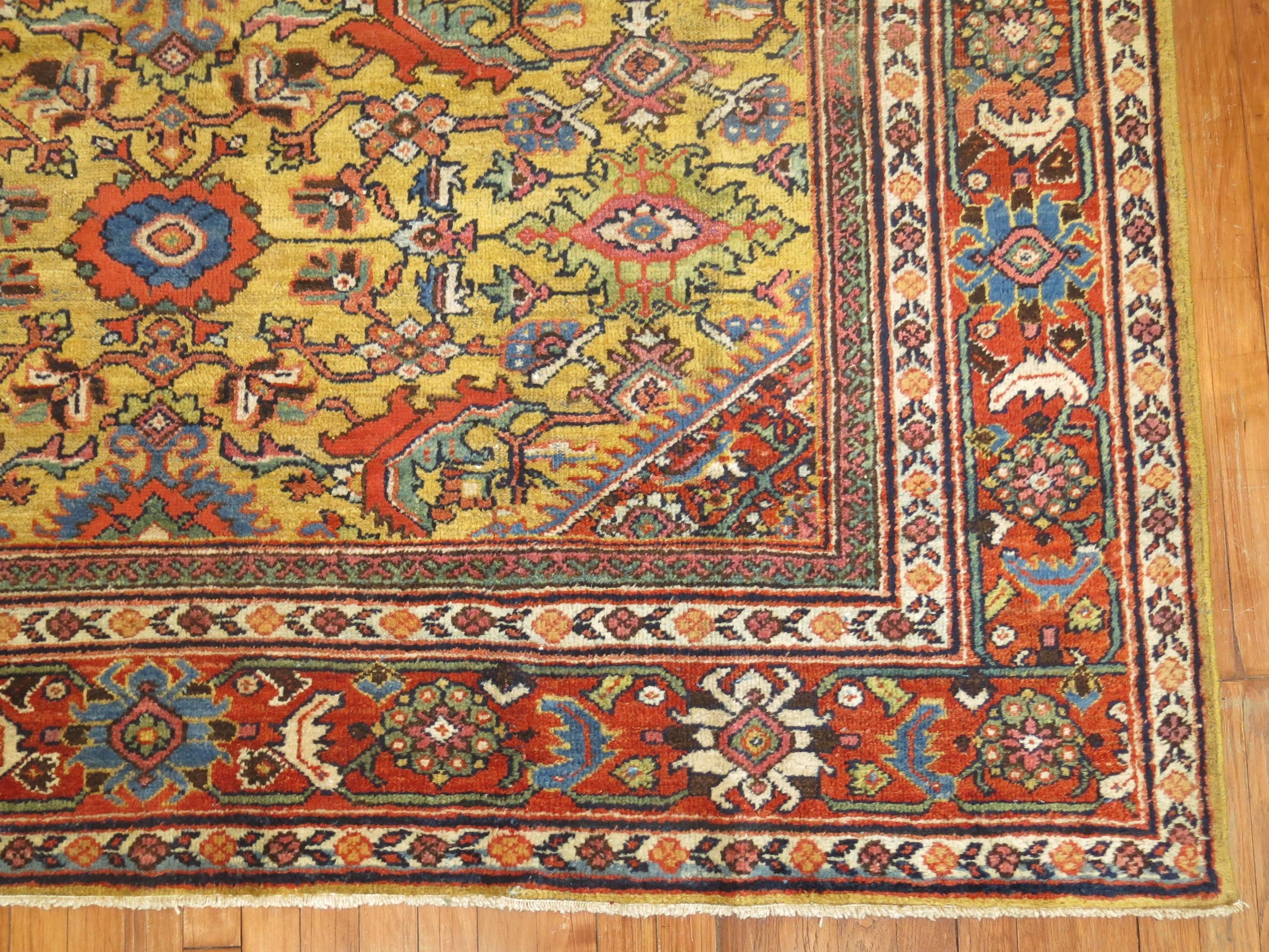 Highly decorative Persian Mahal rug with a rare goldenrod colored field. Pretty accents in rust, blues, tomato red and green.

Measures: 6'10” x 9'8”.