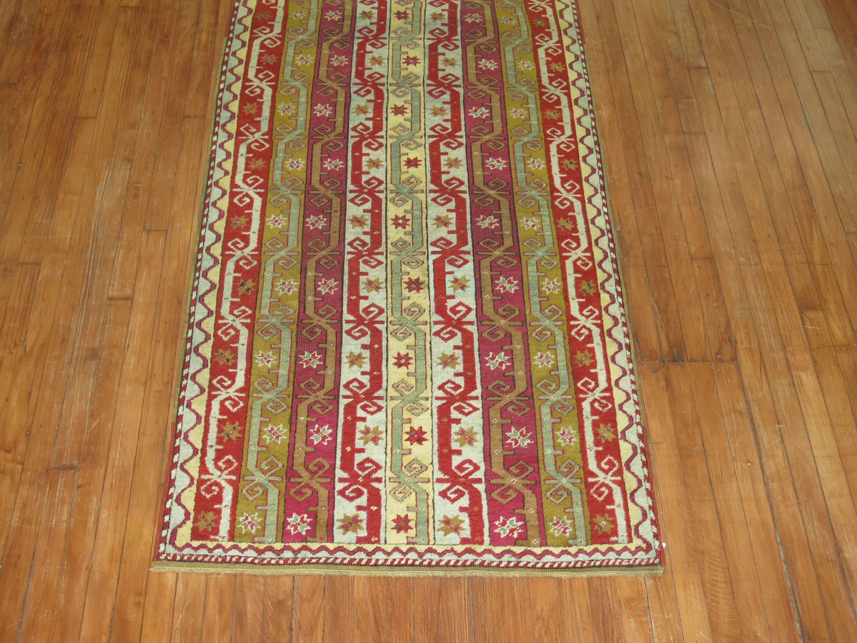 An authentic one of a kind Turkish Ghiordes long runner.

Ghiordes weavings from Northwest Turkey have a long and distinguished history. These particular rugs are known especially for high quality prayer rugs of early date with exceptionally