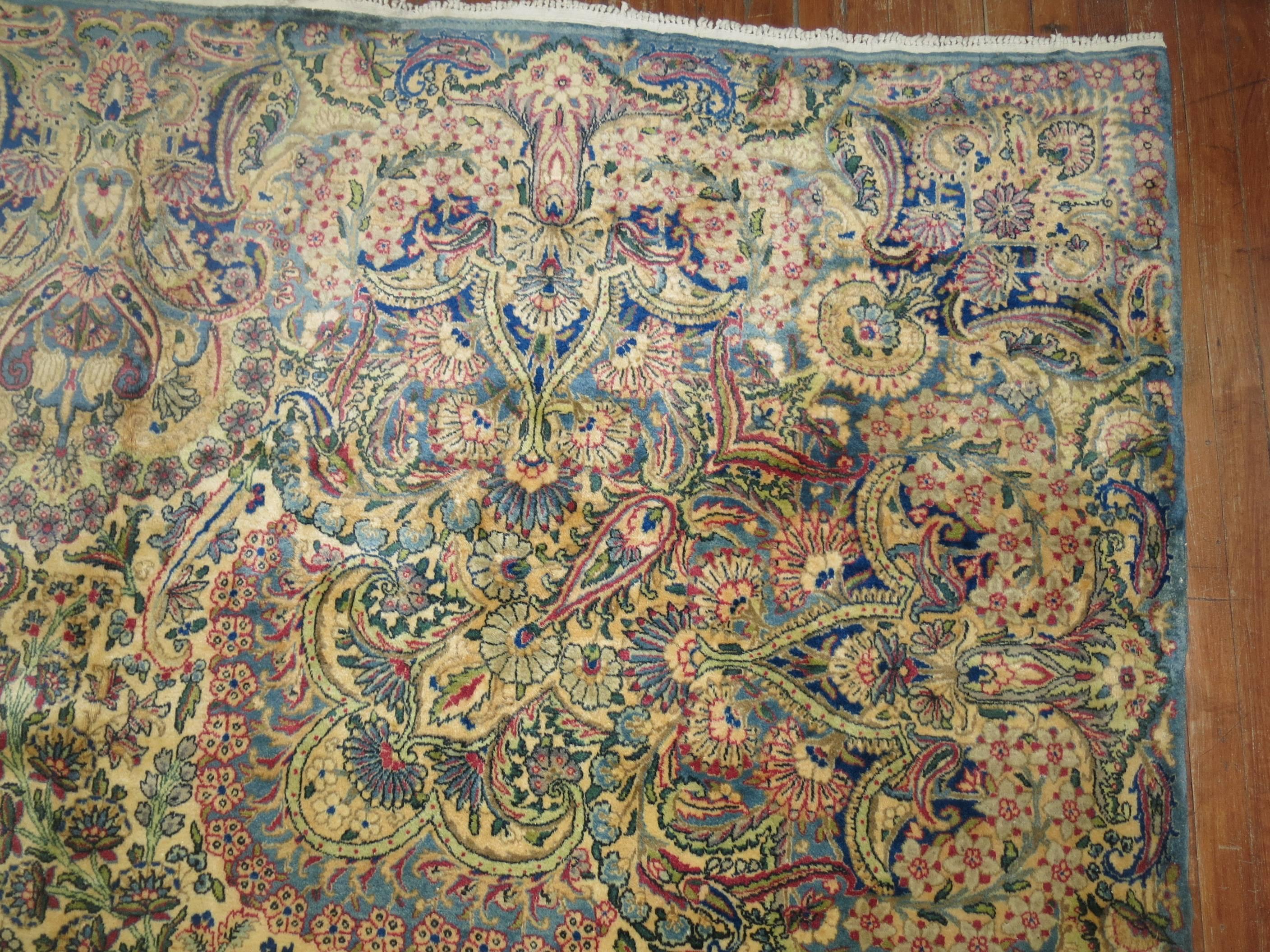An incredible palace size earlier 20th century Kermanshah rug in predominant blues, gray and raspberry. Woven with the finest of Manchester wool.

Measures: 11'8'' x 21'8''

Kirman was a very important weaving centre dating from the Golden Age