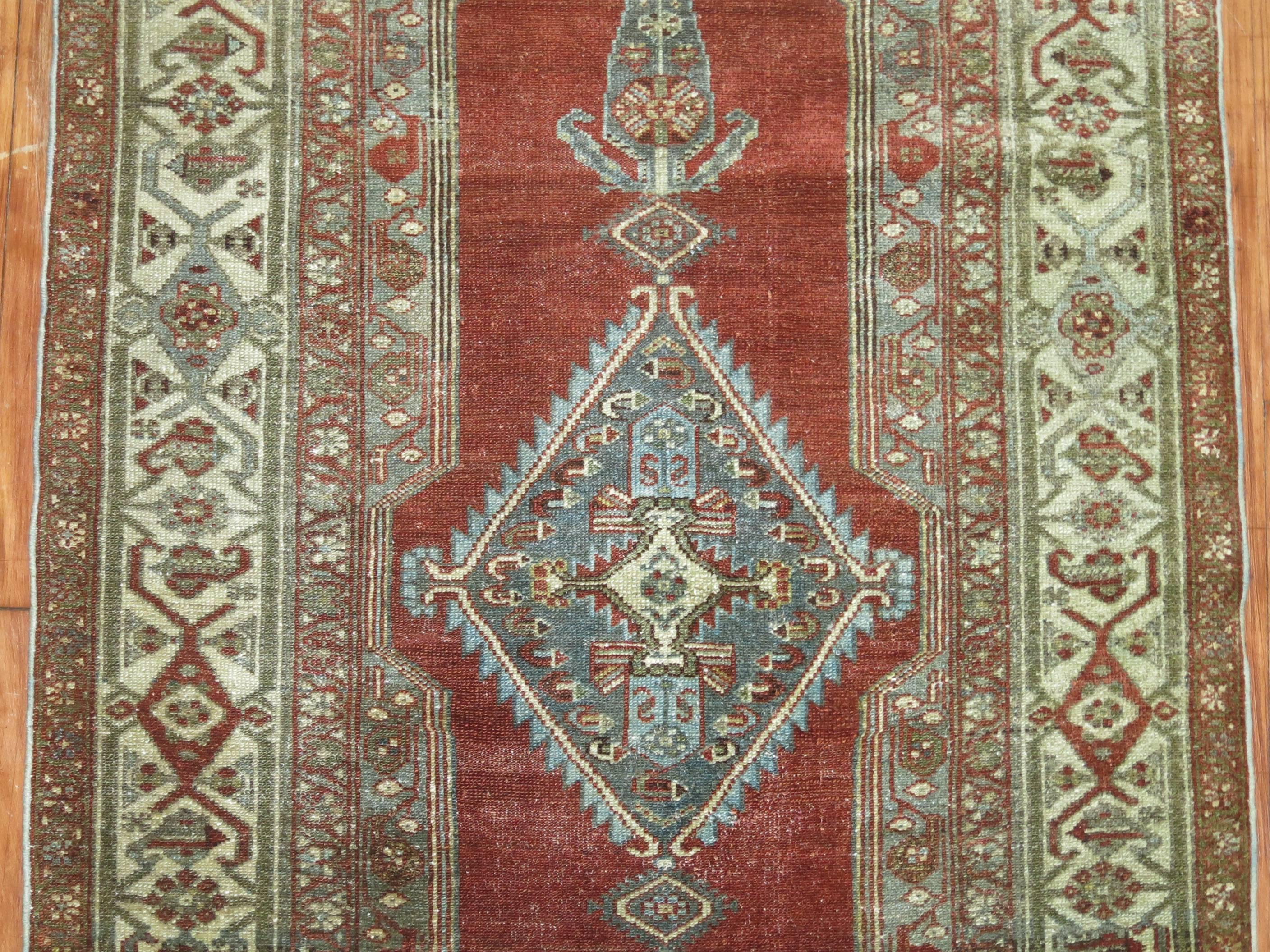 An early 20th century Persian Malayer rug with a brown rust field accents in gray, blue and green,

circa 1930, measures: 3'3