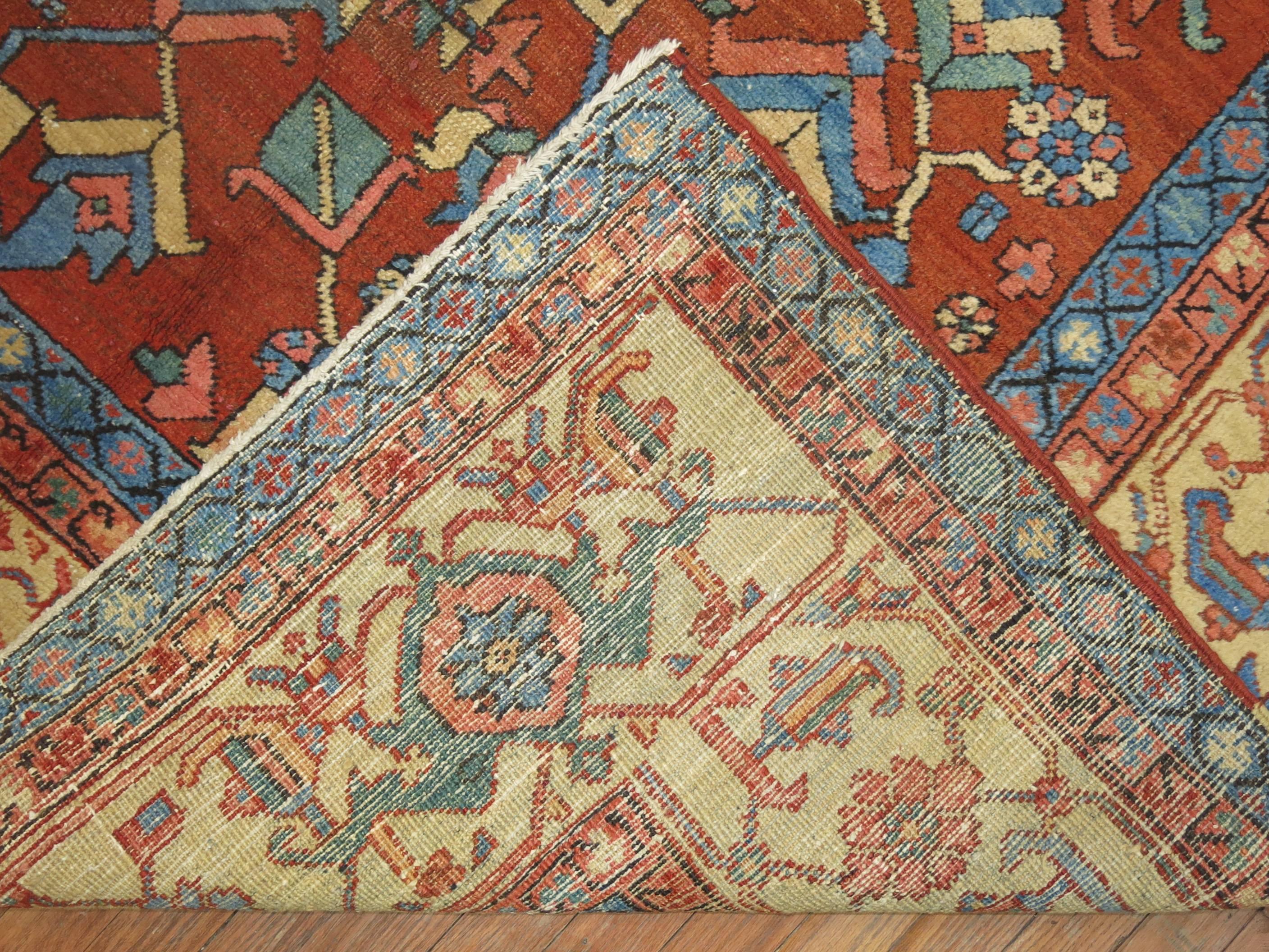 Early 20th century Serapi Heriz rug with cream border, accents in robin egg blues, celery green, teals, terracotta on a brick colored field,

circa 1920. Measures: 9'7