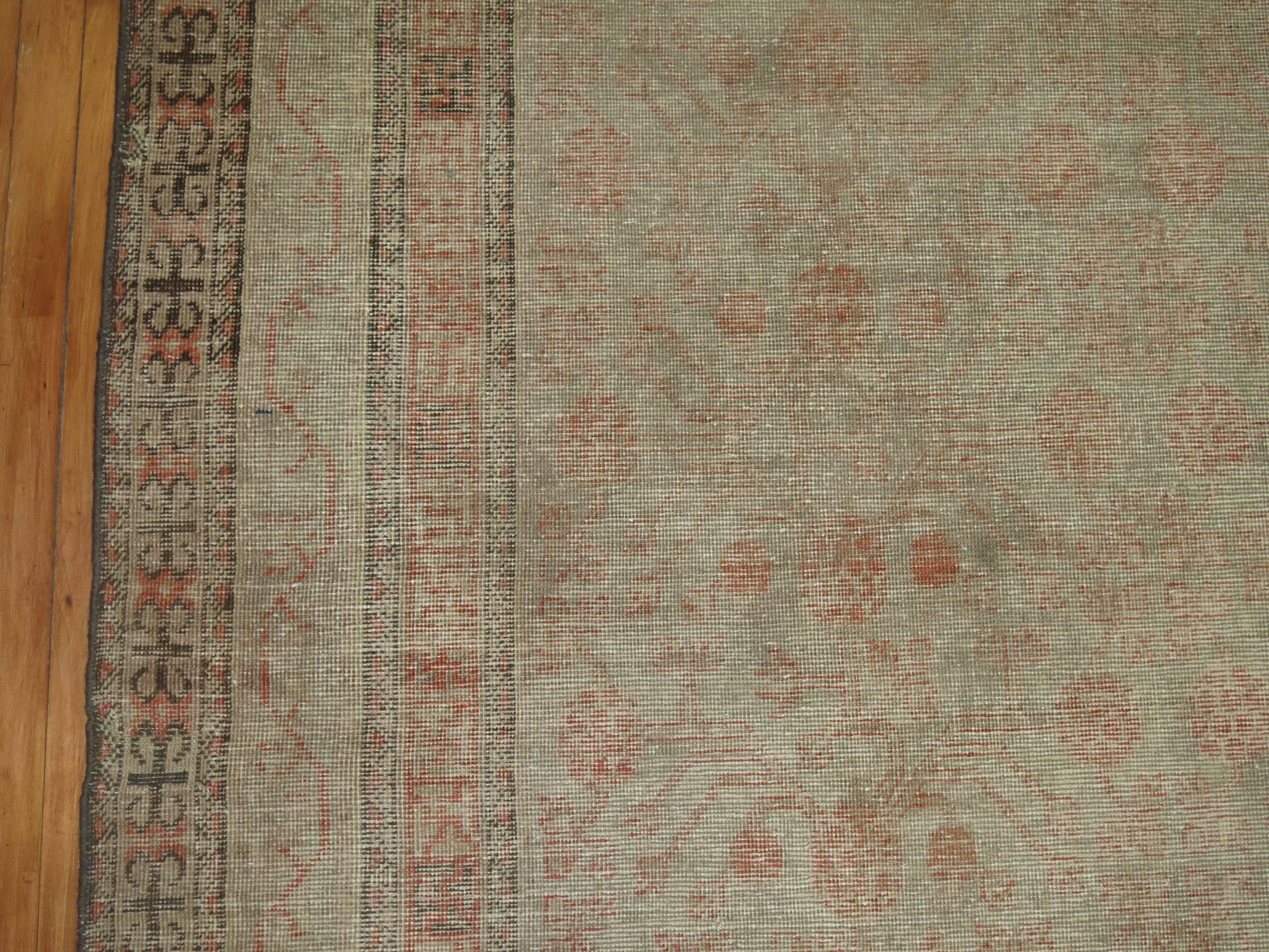Faded Distressed Khotan rug in a gallery format,

circa late 19th century, measures: 6'3