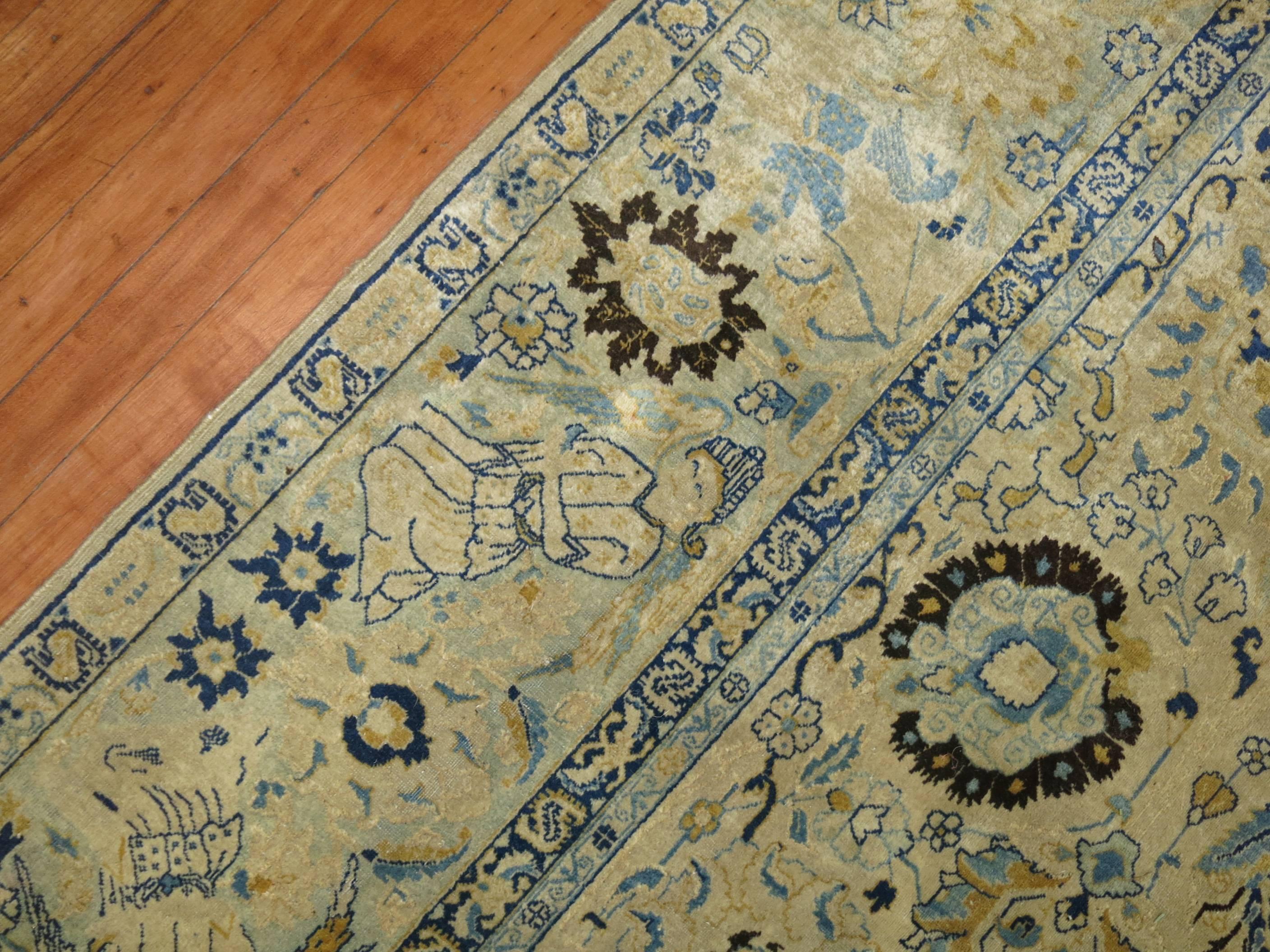 Authentic early 20th century earth toned Persian Tabriz featuring a pictorial border with mysterious angels. Great color, quality, condition and patina. Predominantly white and blue

6'6'' x 10'1''