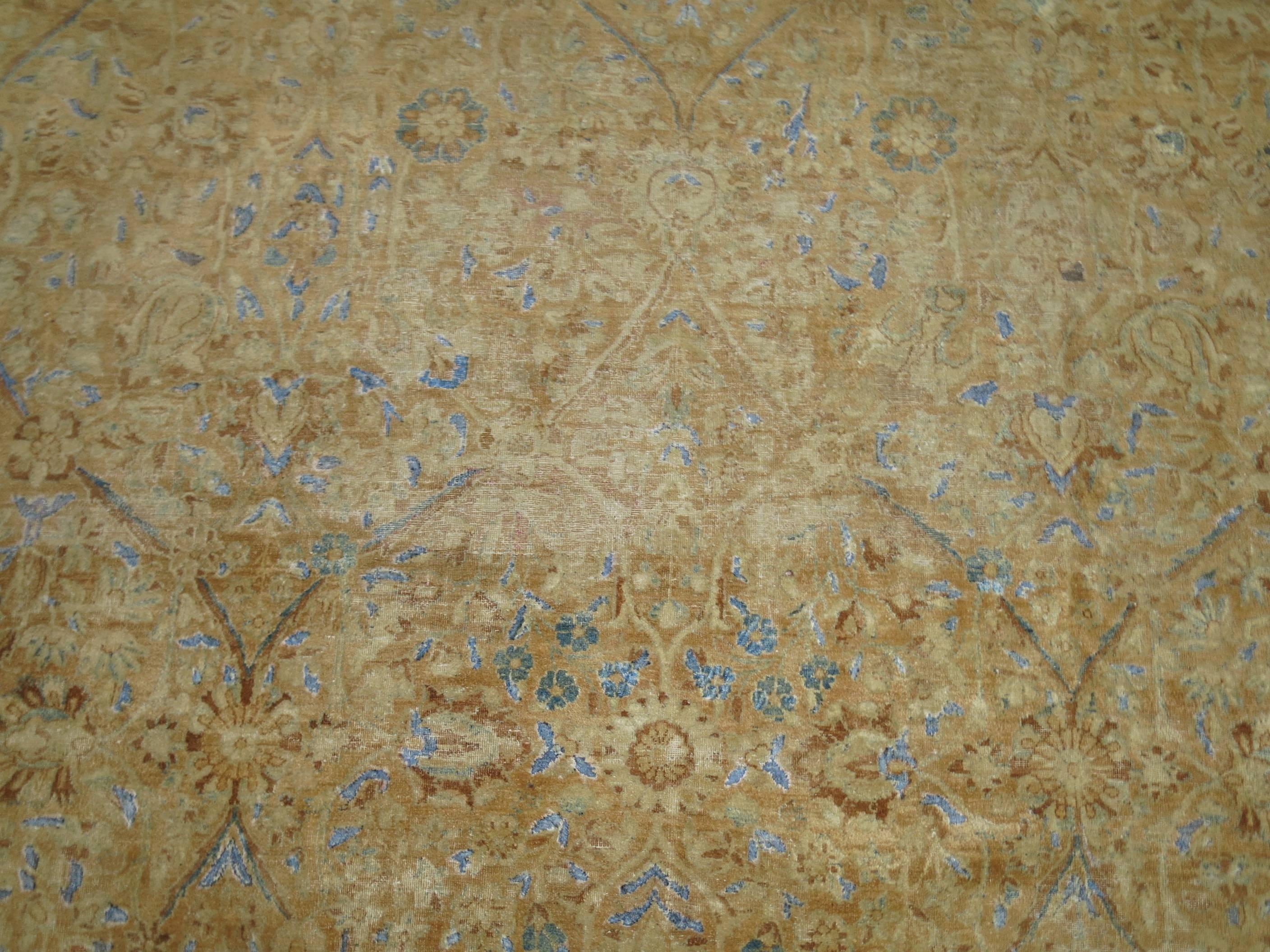 A room size handmade Persian Kerman rug, predominant warm tones with splashes of robin eggs blue,

circa 1920. Measures: 8'11