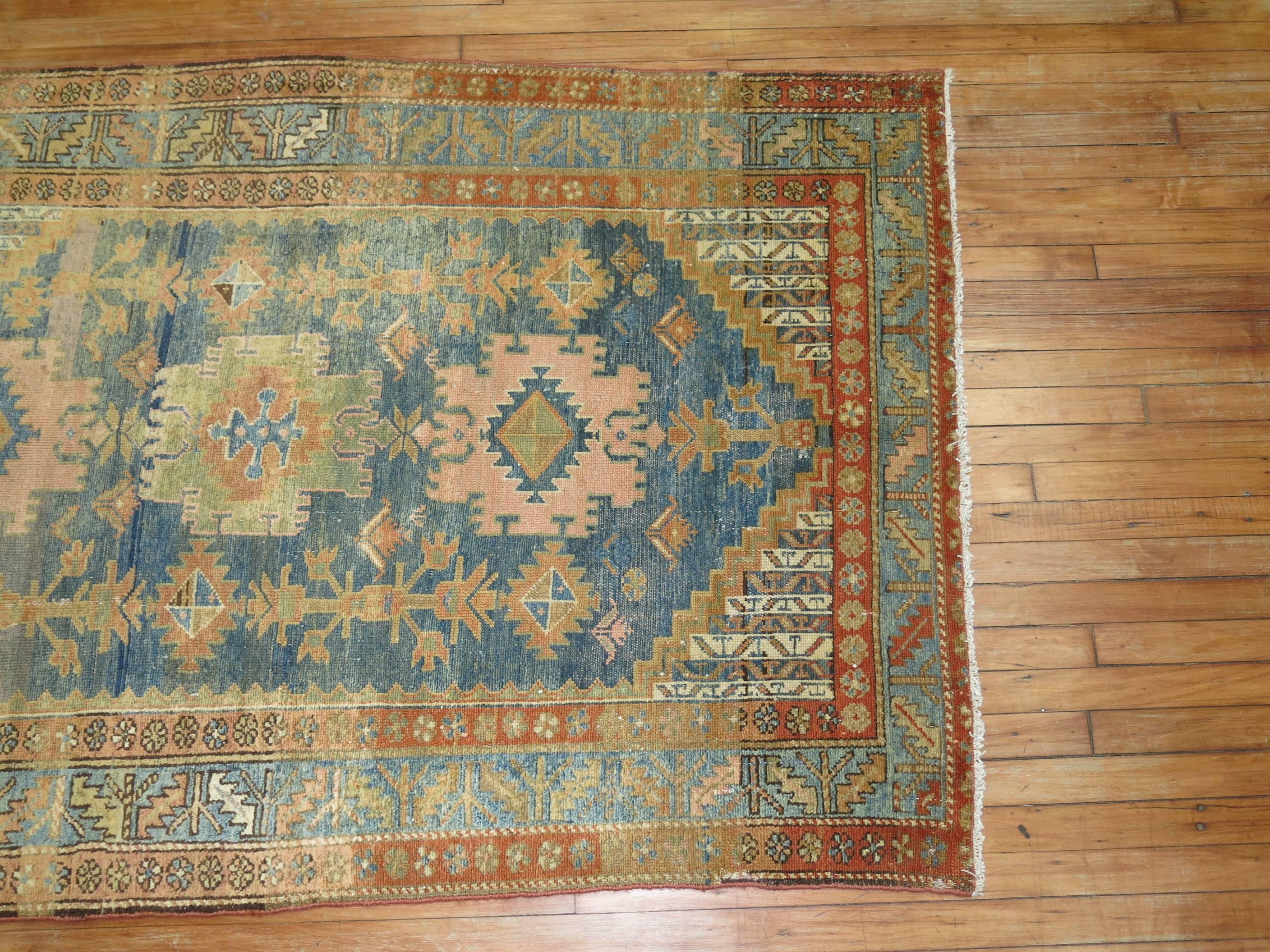 A Persian Malayer rug in pale blue and apricot tones.