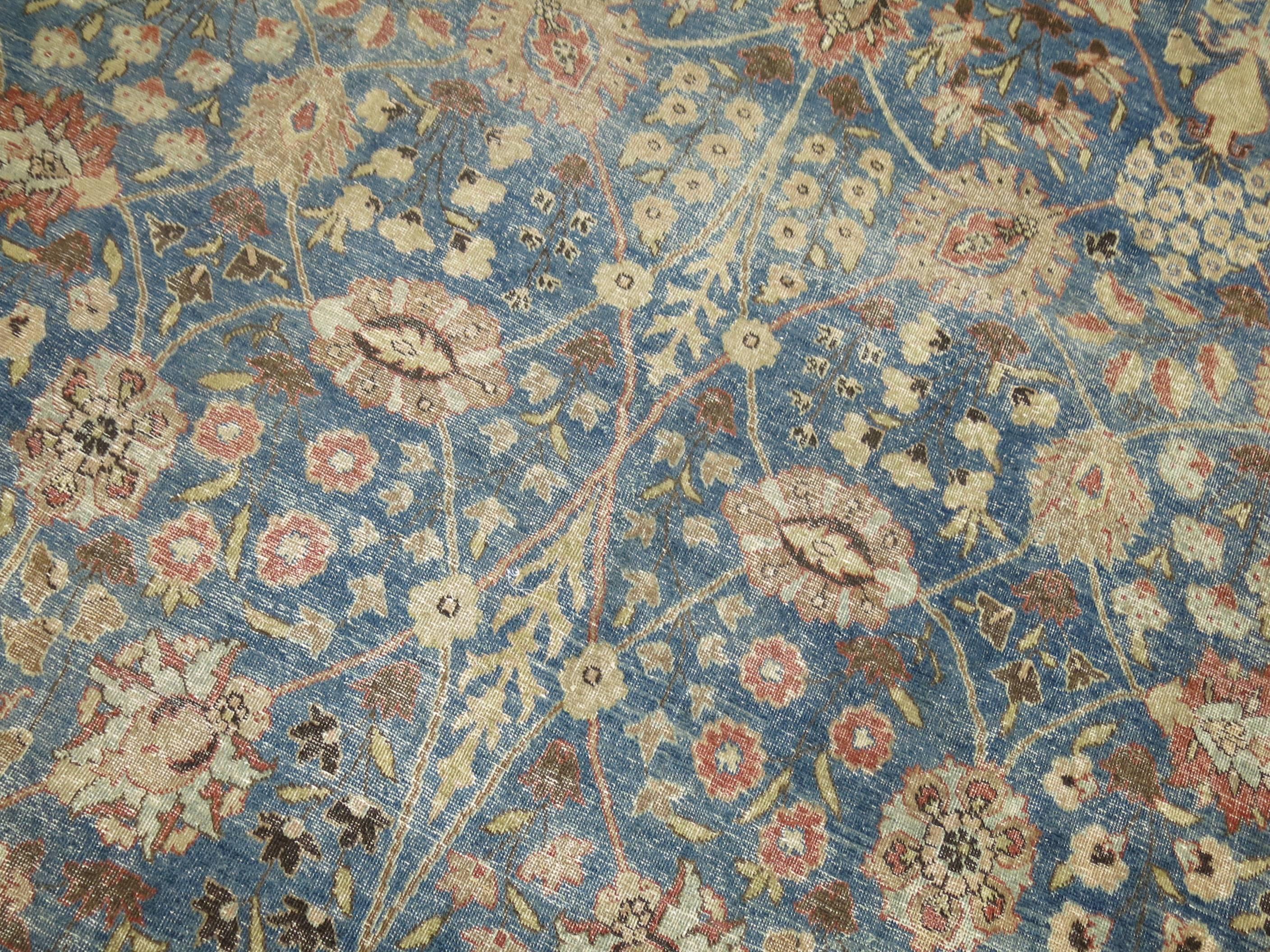 An authentic antique Persian Tabriz rug featuring a background color of 2020 Pantone color of the year Classic blue 19-4052,

circa 1920. Measures: 9'9