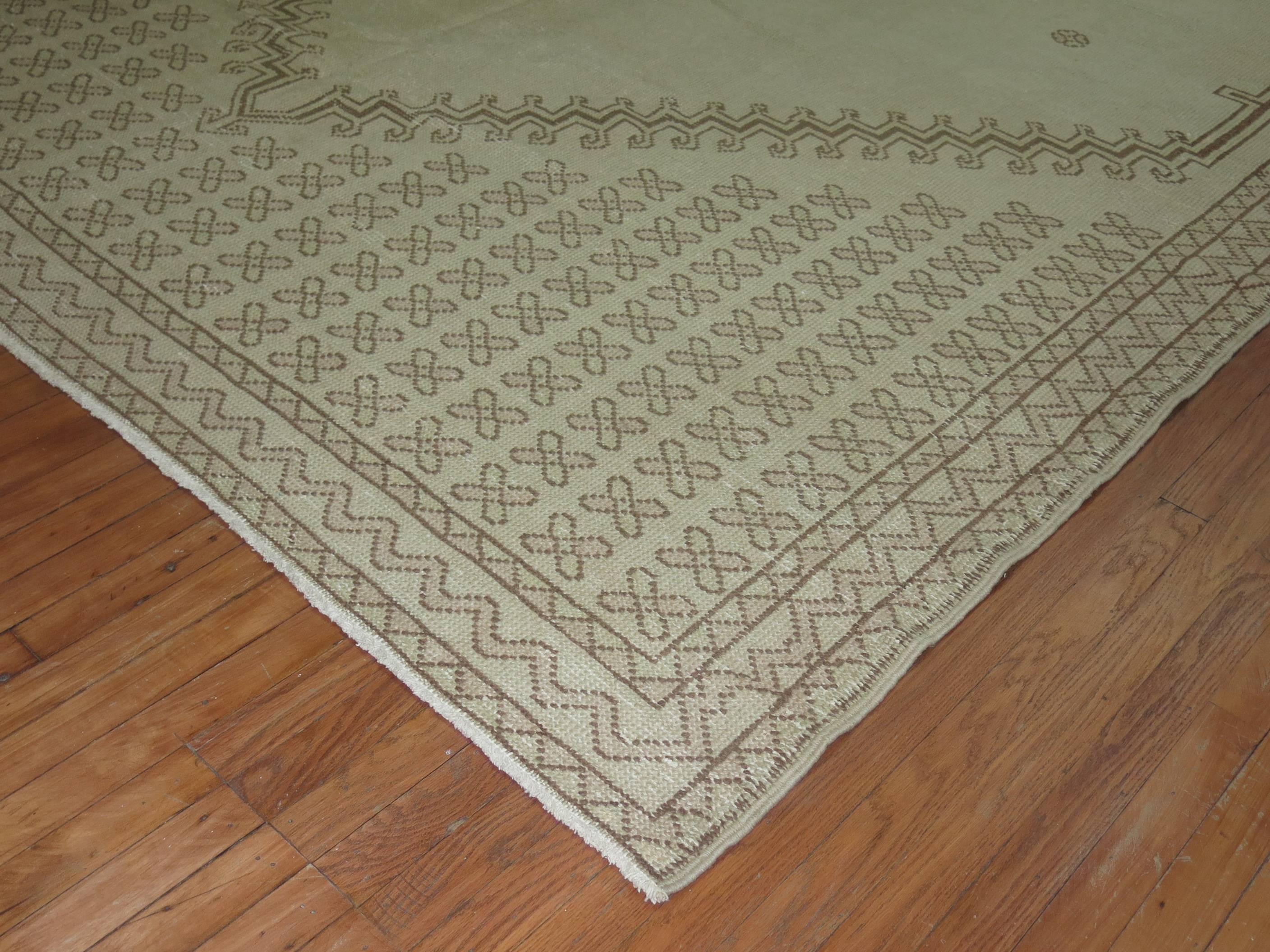 Rare size vintage Moroccan rug in khaki and brown. Some blush outline accents within the field and border. This piece has some scattered visible repairs and originates from the second quarter of the 20th century.

Measures: 8'10