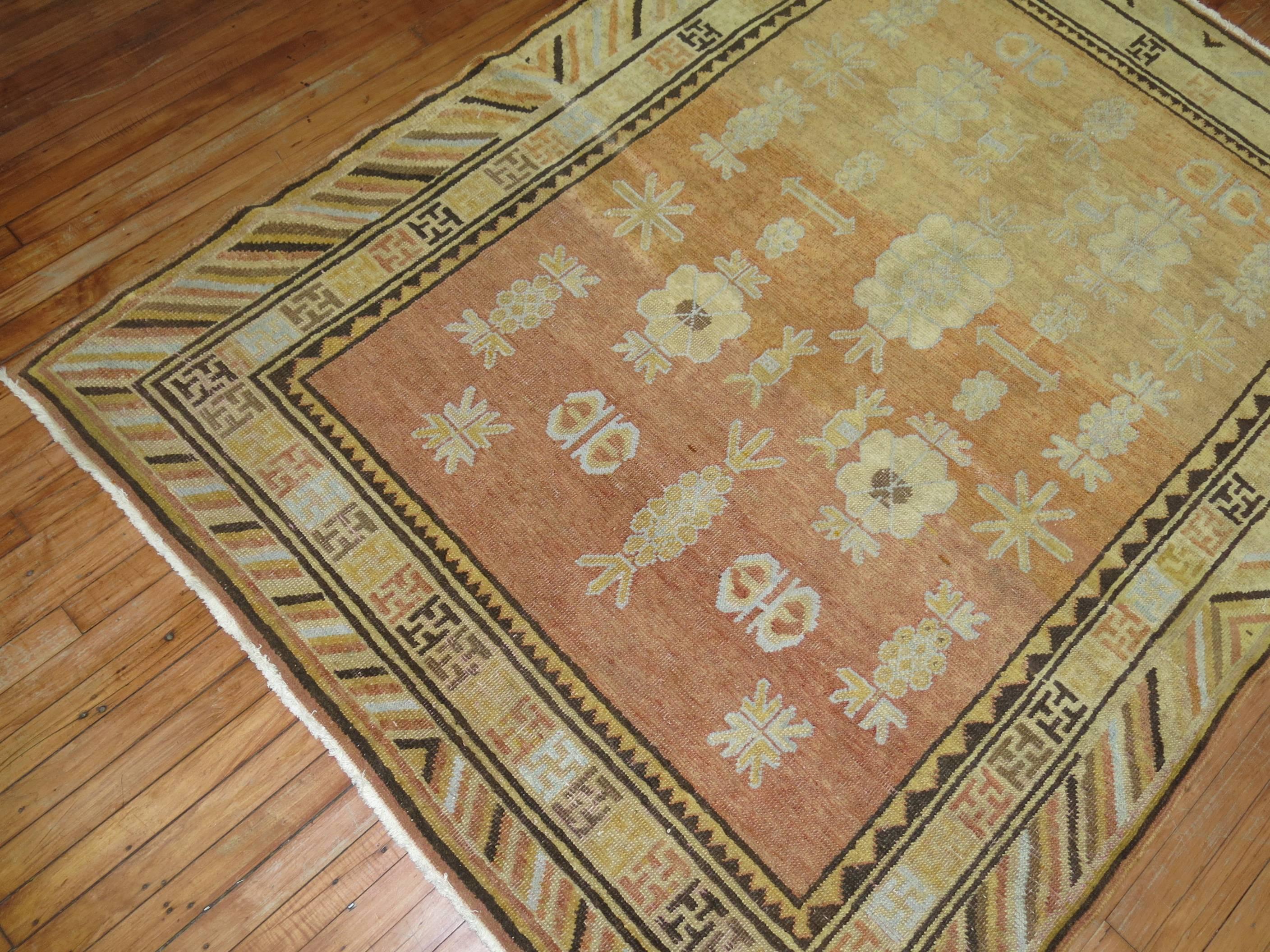 Enchanting antique Khotan rug predominantly apricot and orange.